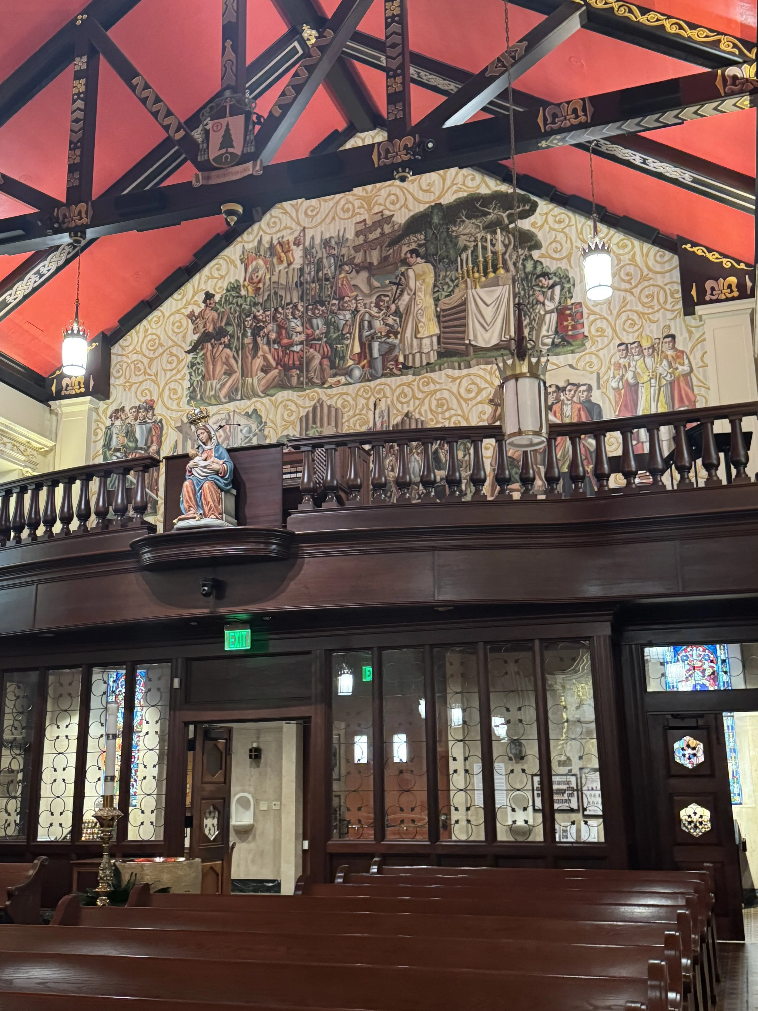 Ornate balcony and painted wall artwork inside the Cathedral Basilica of St. Augustine.