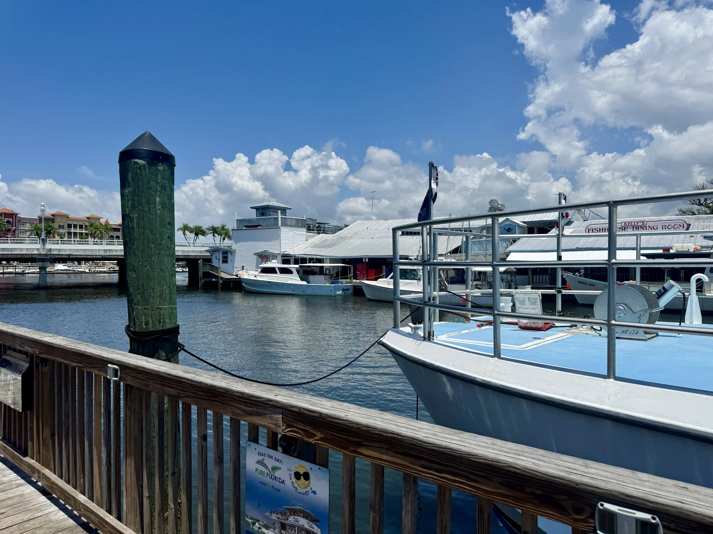 Boats docked along the marina behind Tin City waterfront shops in Naples Florida