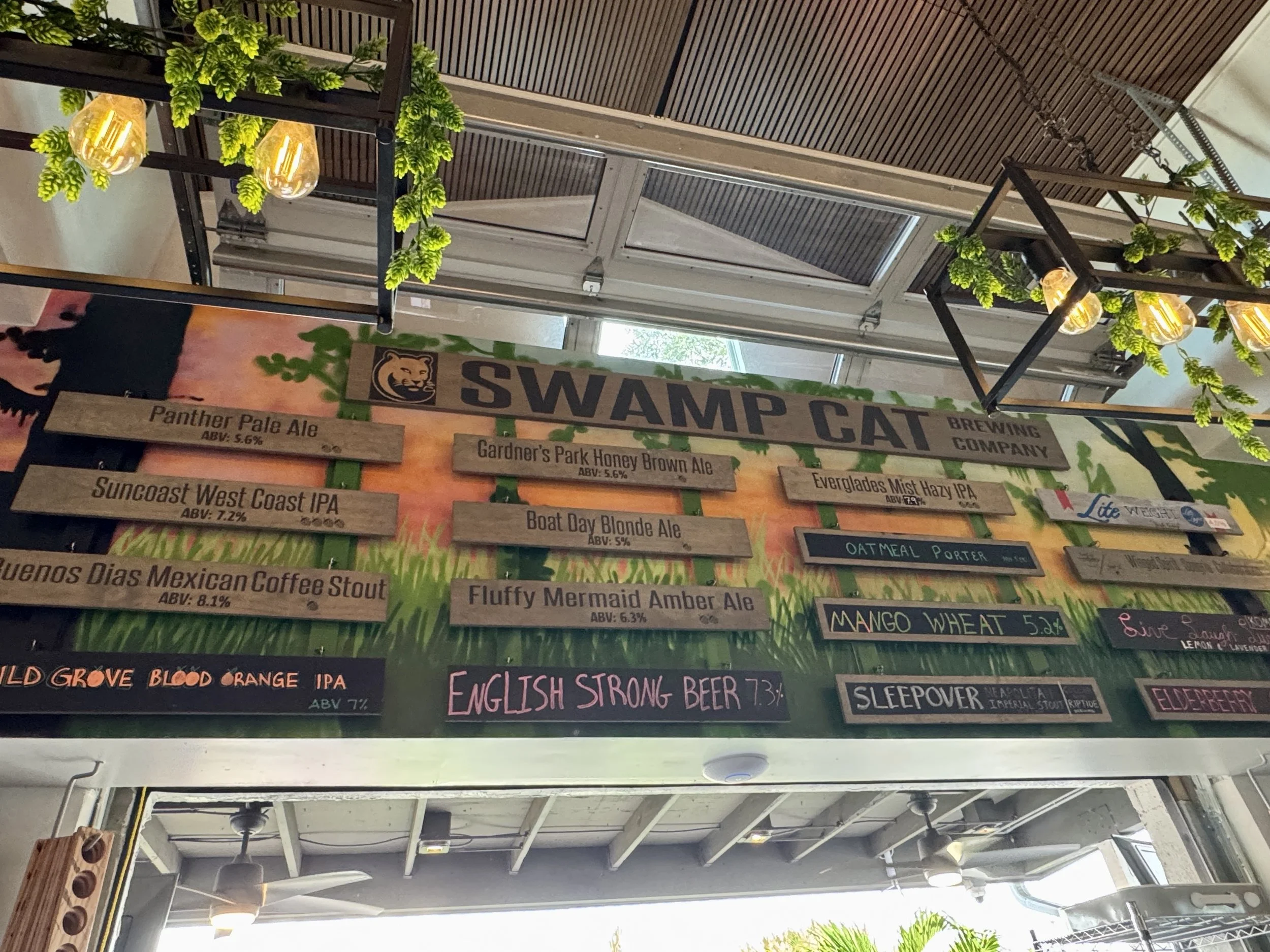 Swamp Cat Brewery sign and outdoor seating area in Fort Myers Florida