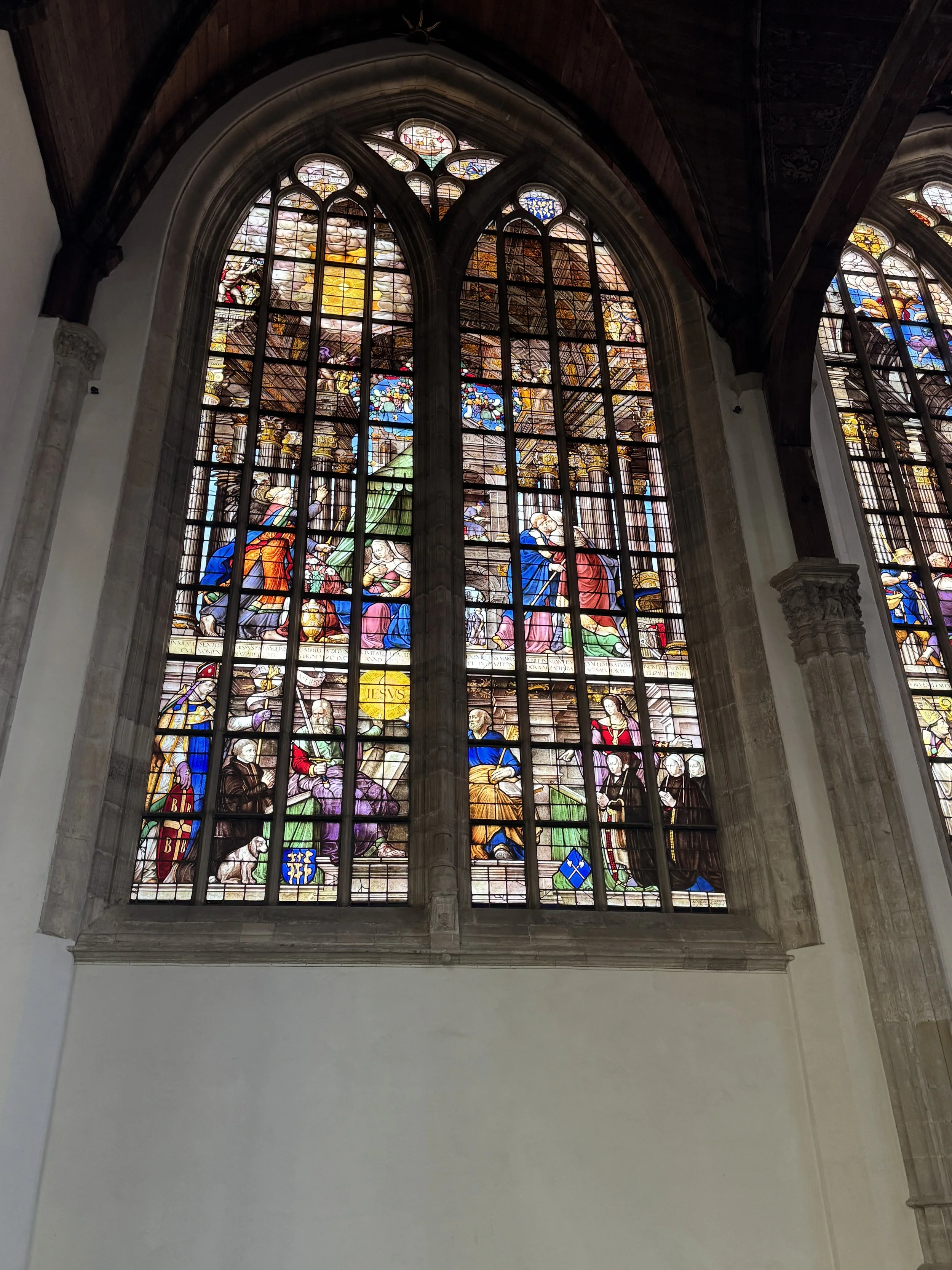Colorful stained glass windows inside Oude Kerk in Amsterdam