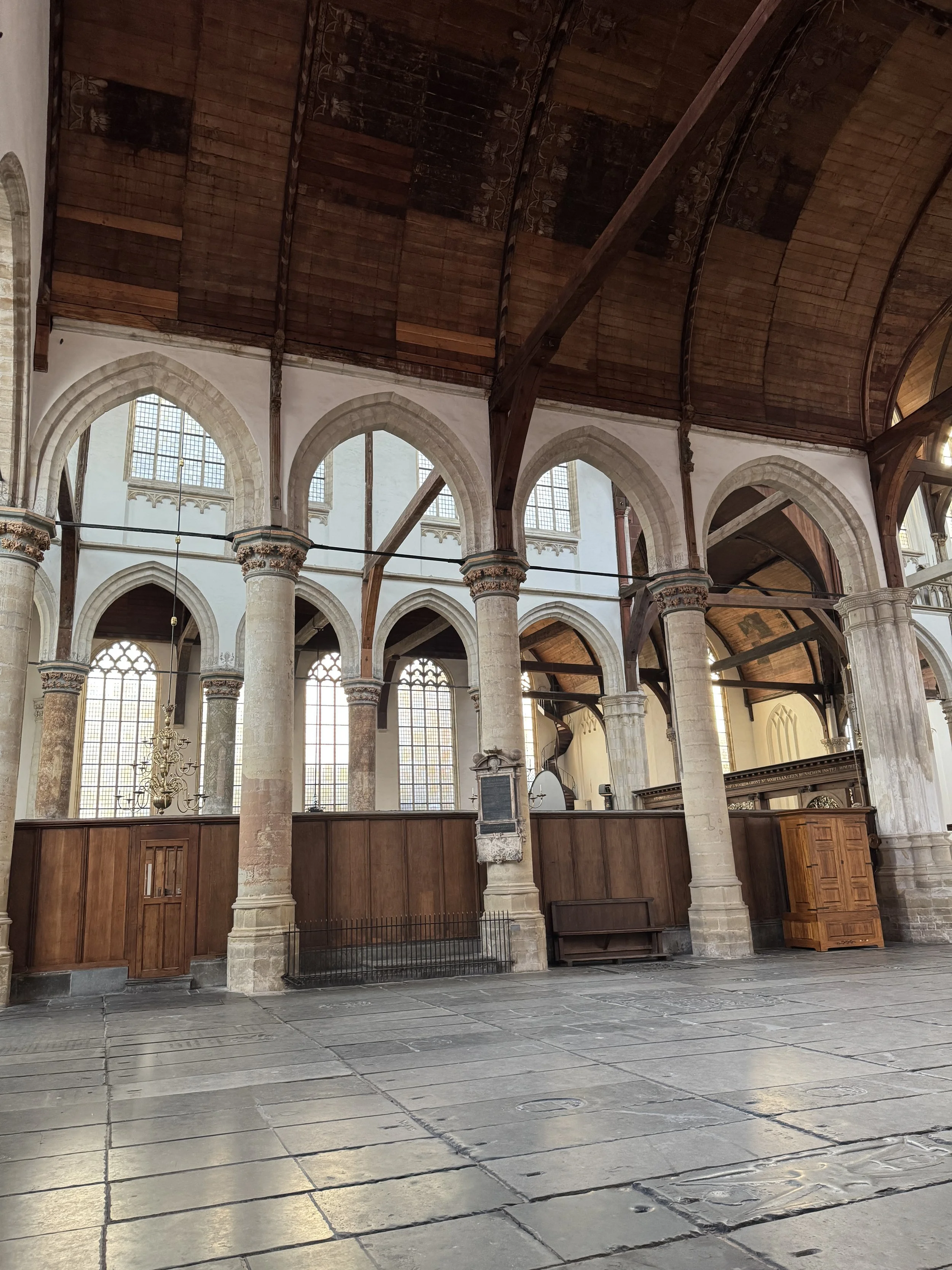 Interior of Oude Kerk with high vaulted ceilings and rows of arches in Amsterdam