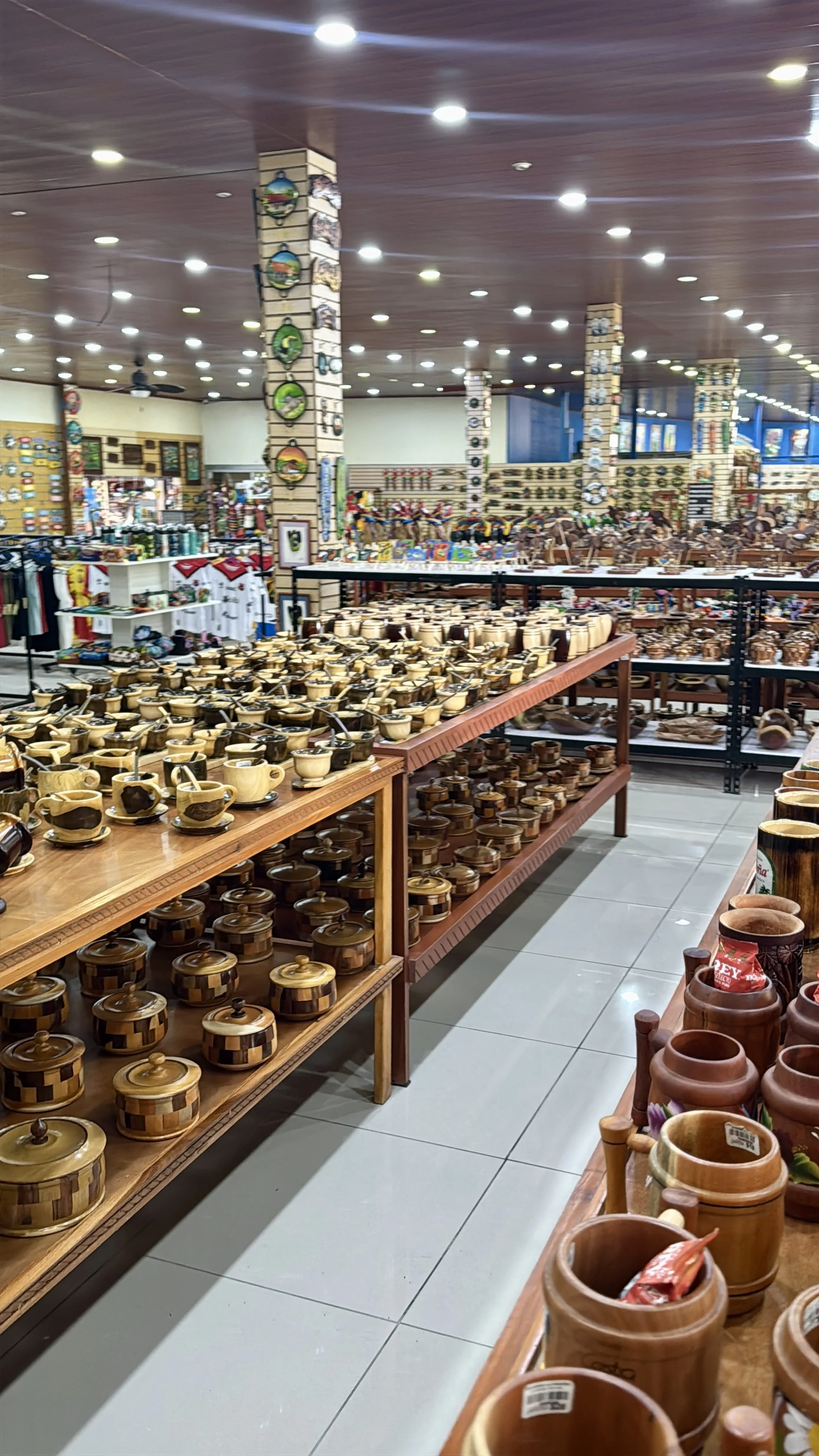 Interior of La Pradera Souvenirs showing long aisles filled with pottery and handcrafted items.