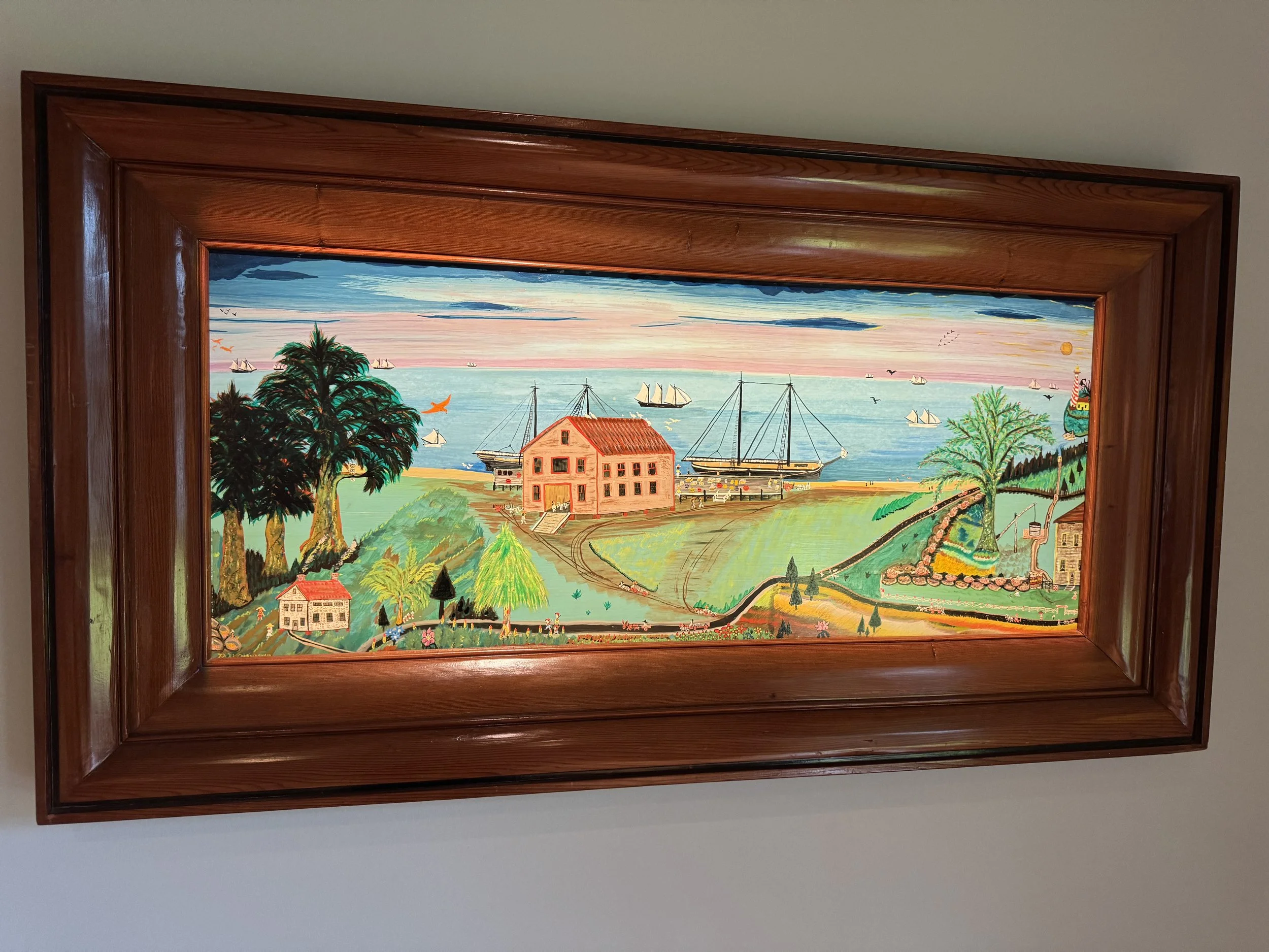 Folk art style landscape painting displayed inside the Mennello Museum of American Art gallery.
