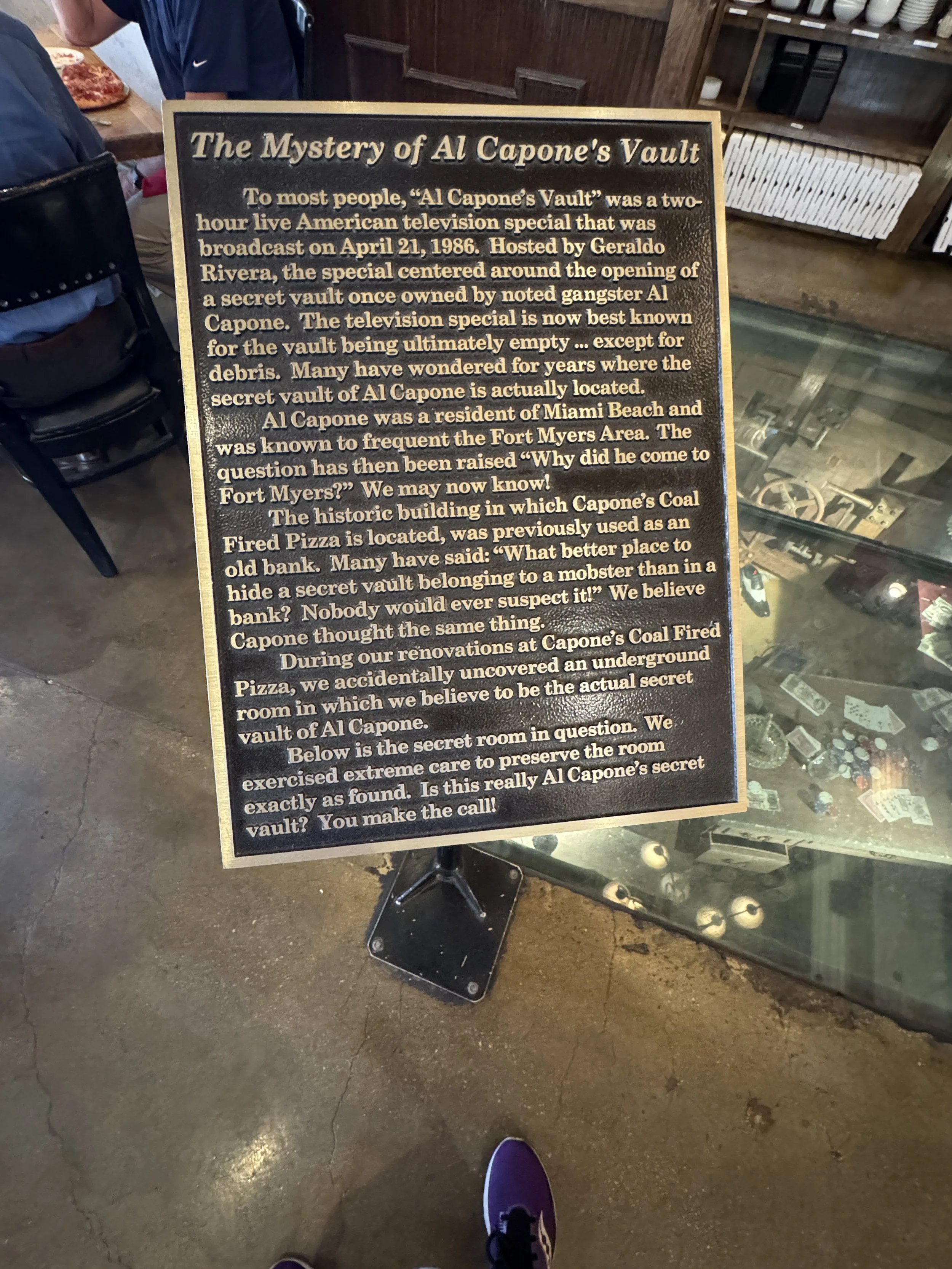 Informational sign explaining the mystery of Al Capone’s vault displayed inside Capone’s restaurant in Fort Myers.