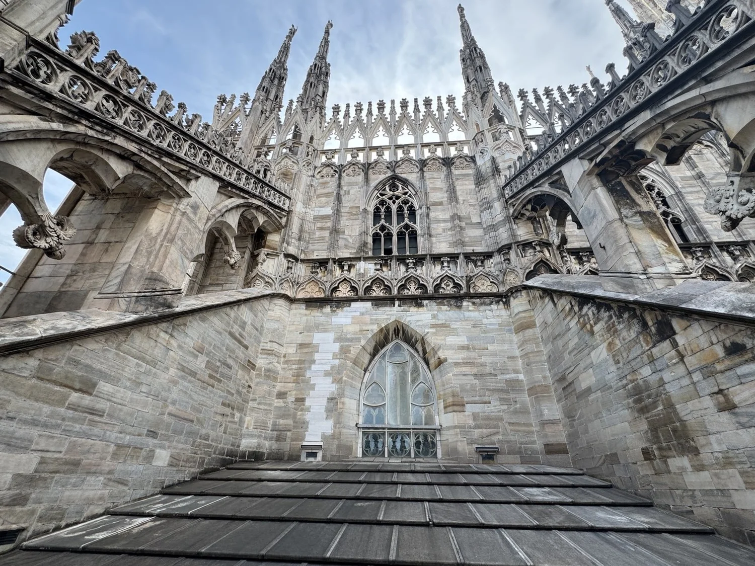 Gothic arches, marble spires and rooftop architecture on the Duomo di Milano terraces.