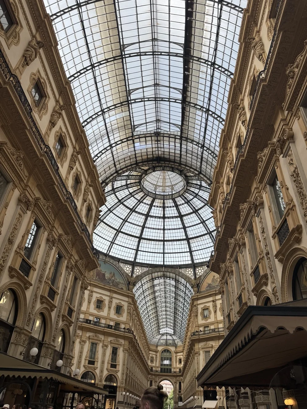 Glass dome and ornate interior of Galleria Vittorio Emanuele II in Milan, Italy.