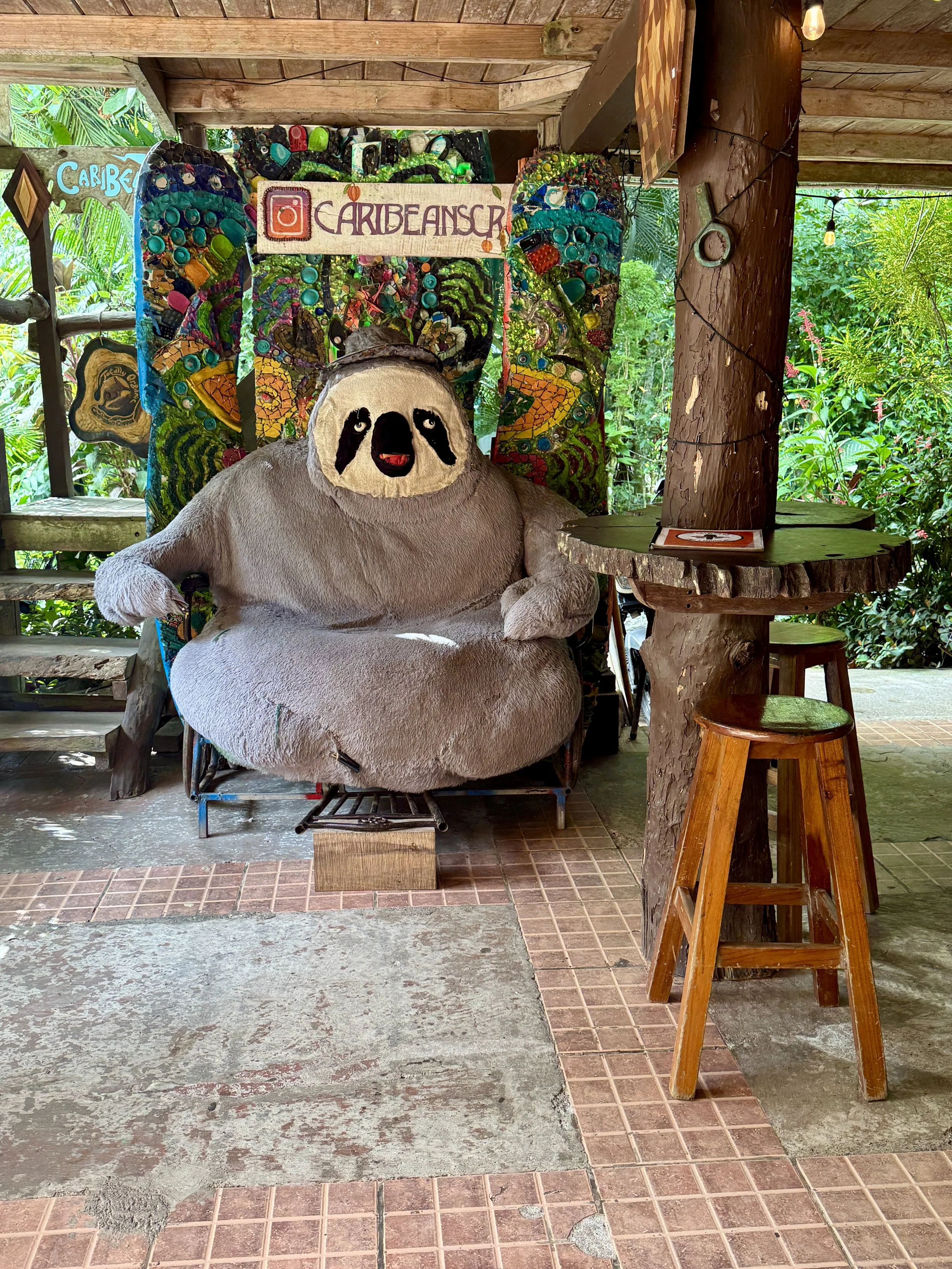Large sloth statue at the entrance of Caribeans Chocolate and Coffee in Puerto Viejo.