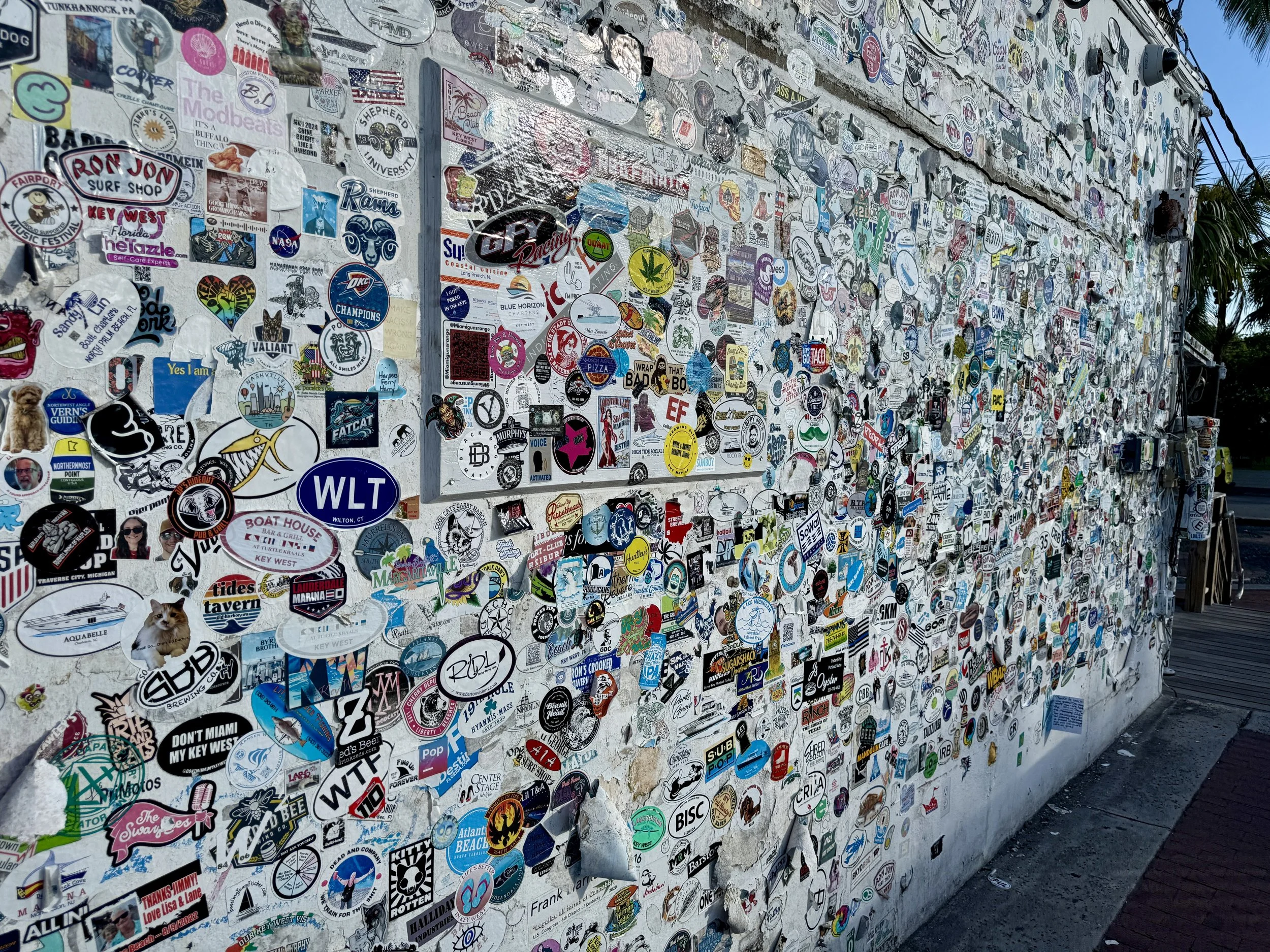 sticker covered wall along Duval street in Key WEst florida