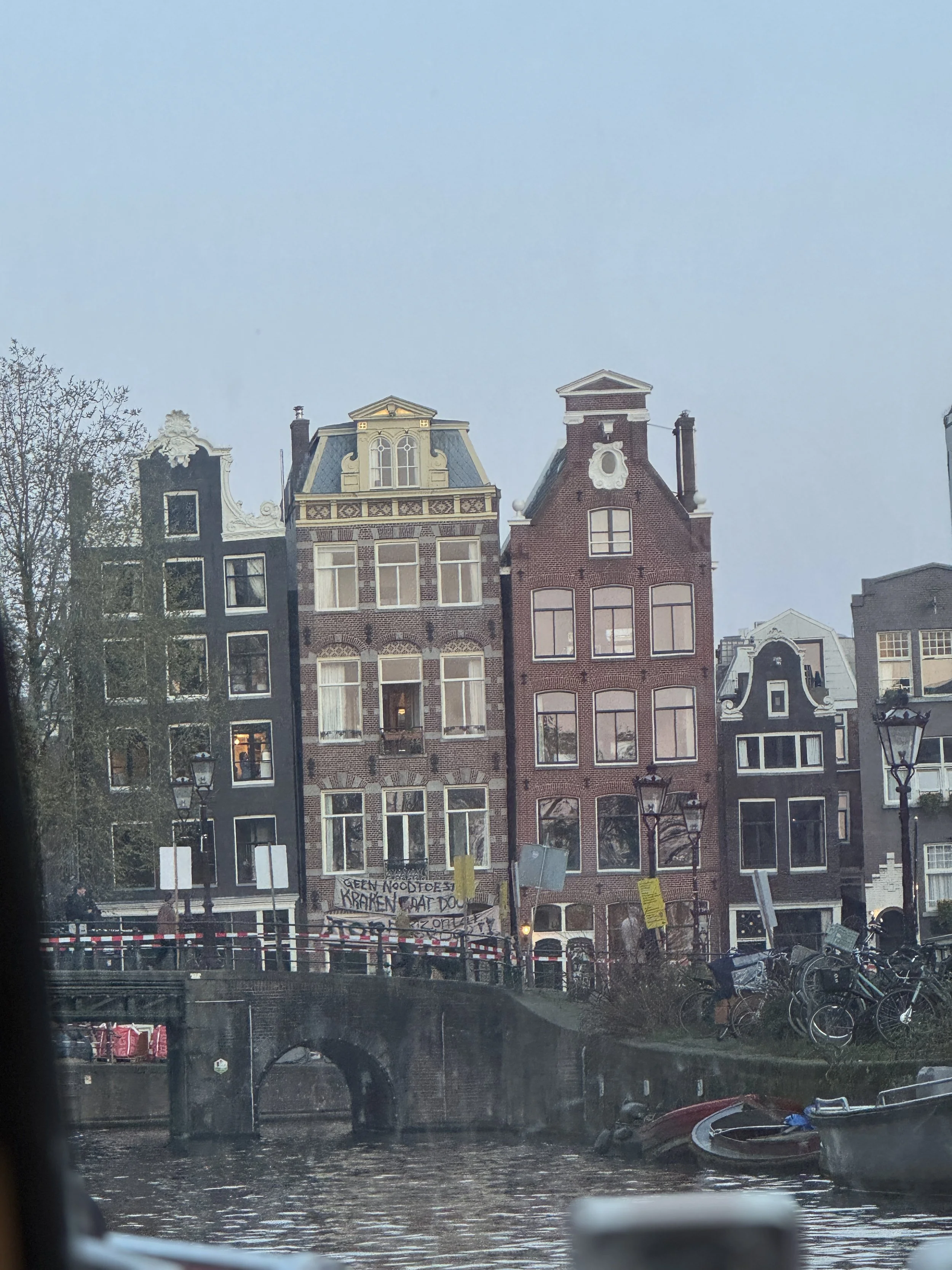 Traditional Dutch canal houses lining a waterfront in Amsterdam during a canal cruise