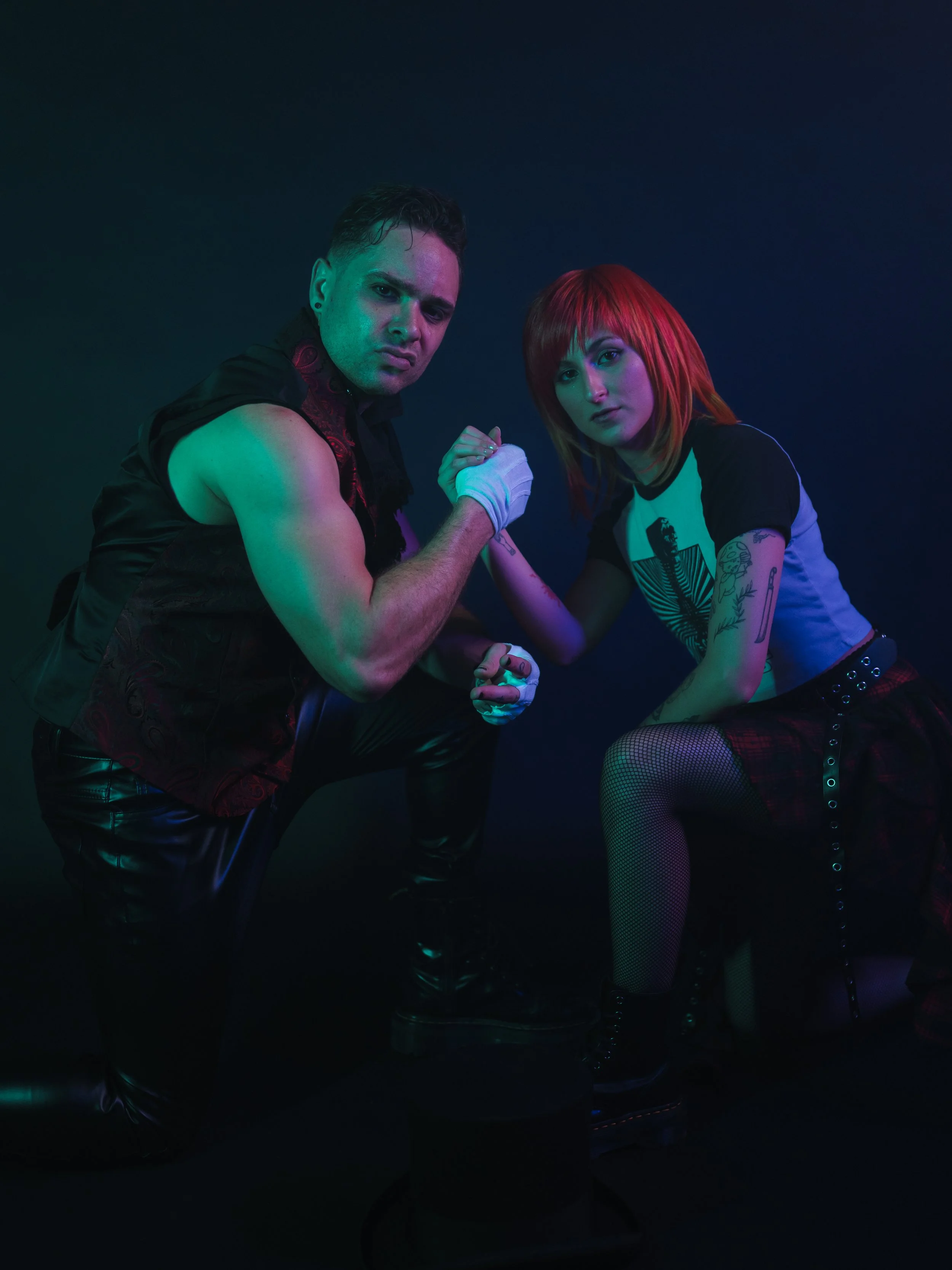 Image of the male lead vocalist shaking hands with the female lead vocalist