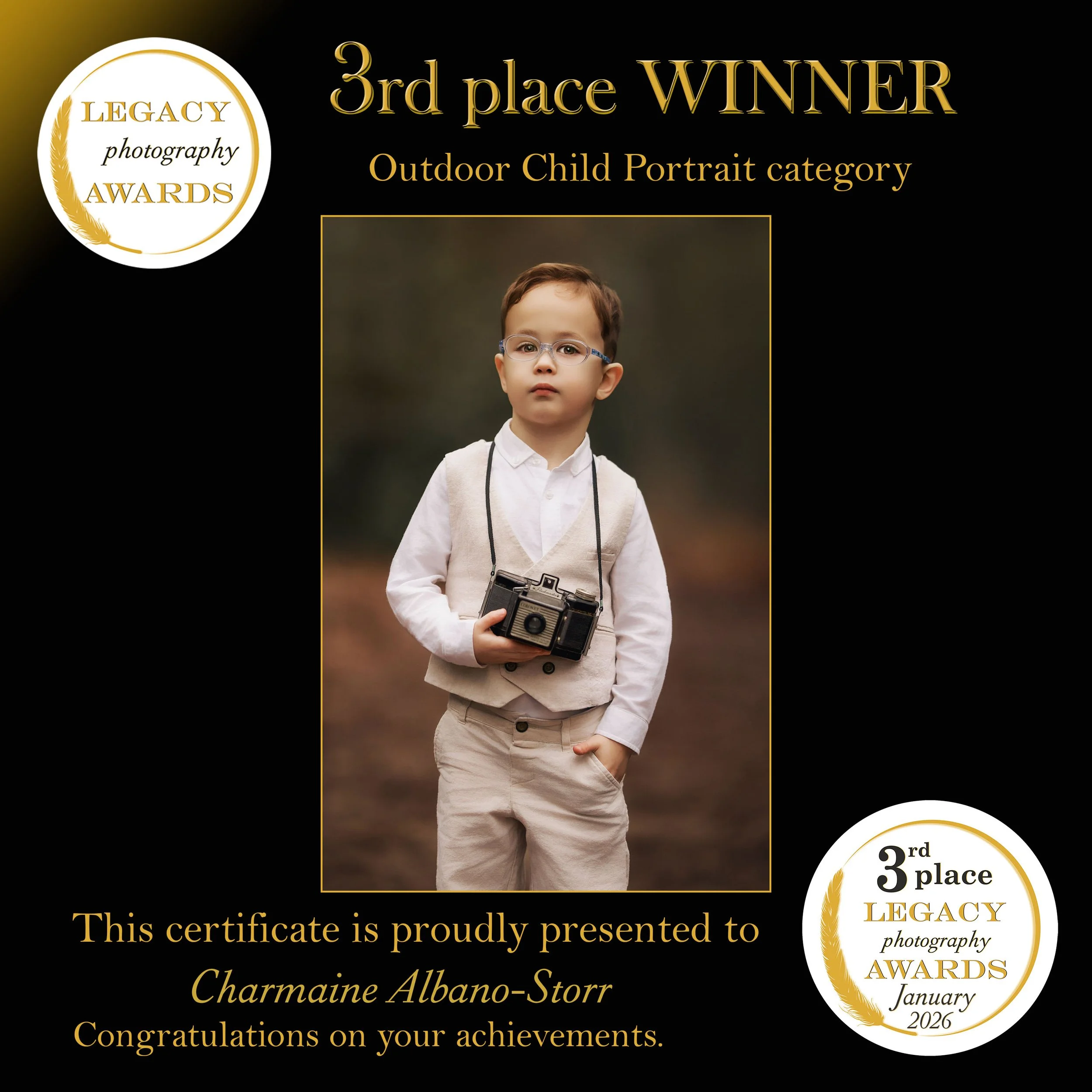 3rd place winner in the Legacy Photography Awards Outdoor Child Portrait category, featuring a young boy with glasses holding a vintage camera.
