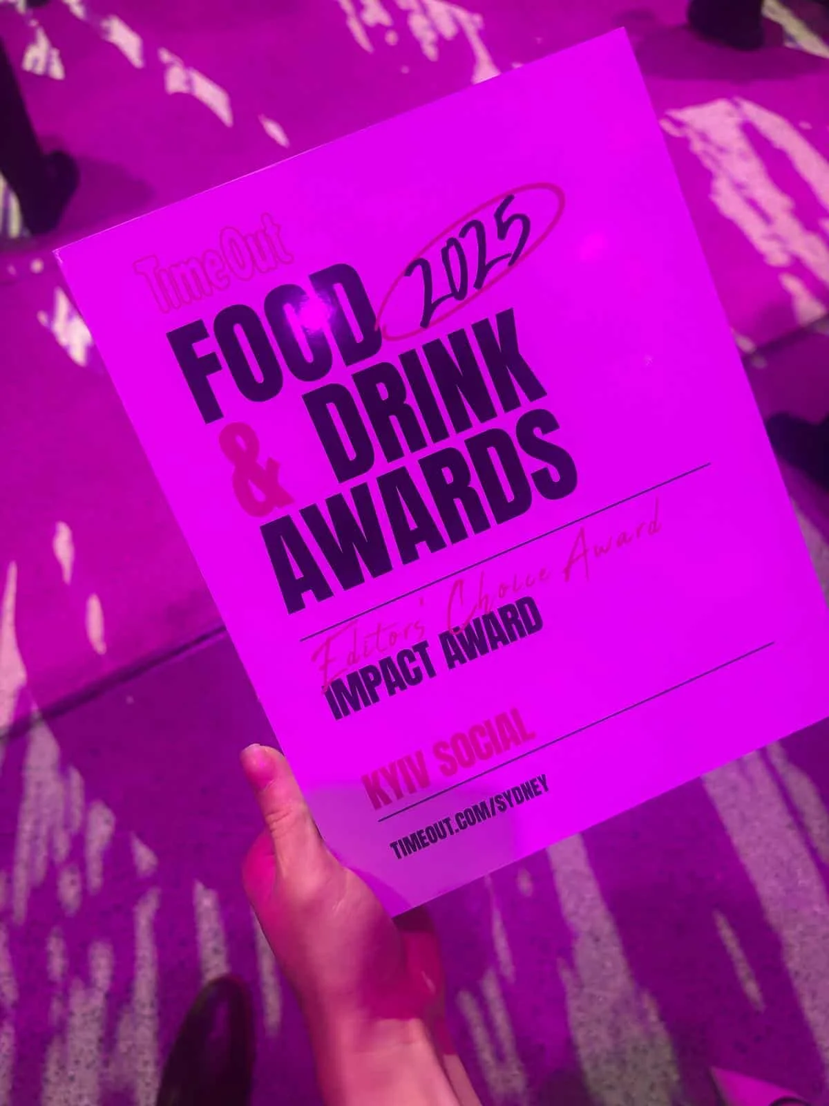 A pink-lit award certificate for the 2023 FUCK'D & DRINK Awards, Impact Award given to Kyiv Social, held at Timeout Sydney.