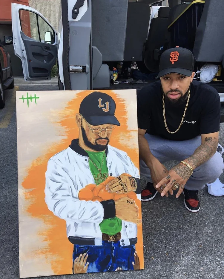 Collector crouching beside his painted portrait