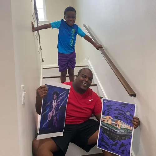 Collector on the stairs holding two paintings
