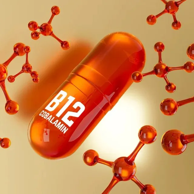 A digital illustration of a capsule labeled 'B12 COBALAMIN' surrounded by molecular structures.
