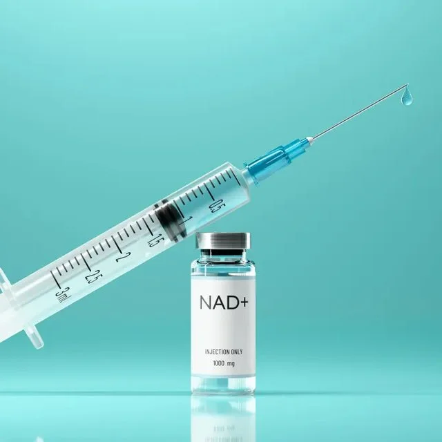 A syringe with a drop of liquid and a vial labeled 'NAD+' on a turquoise background.