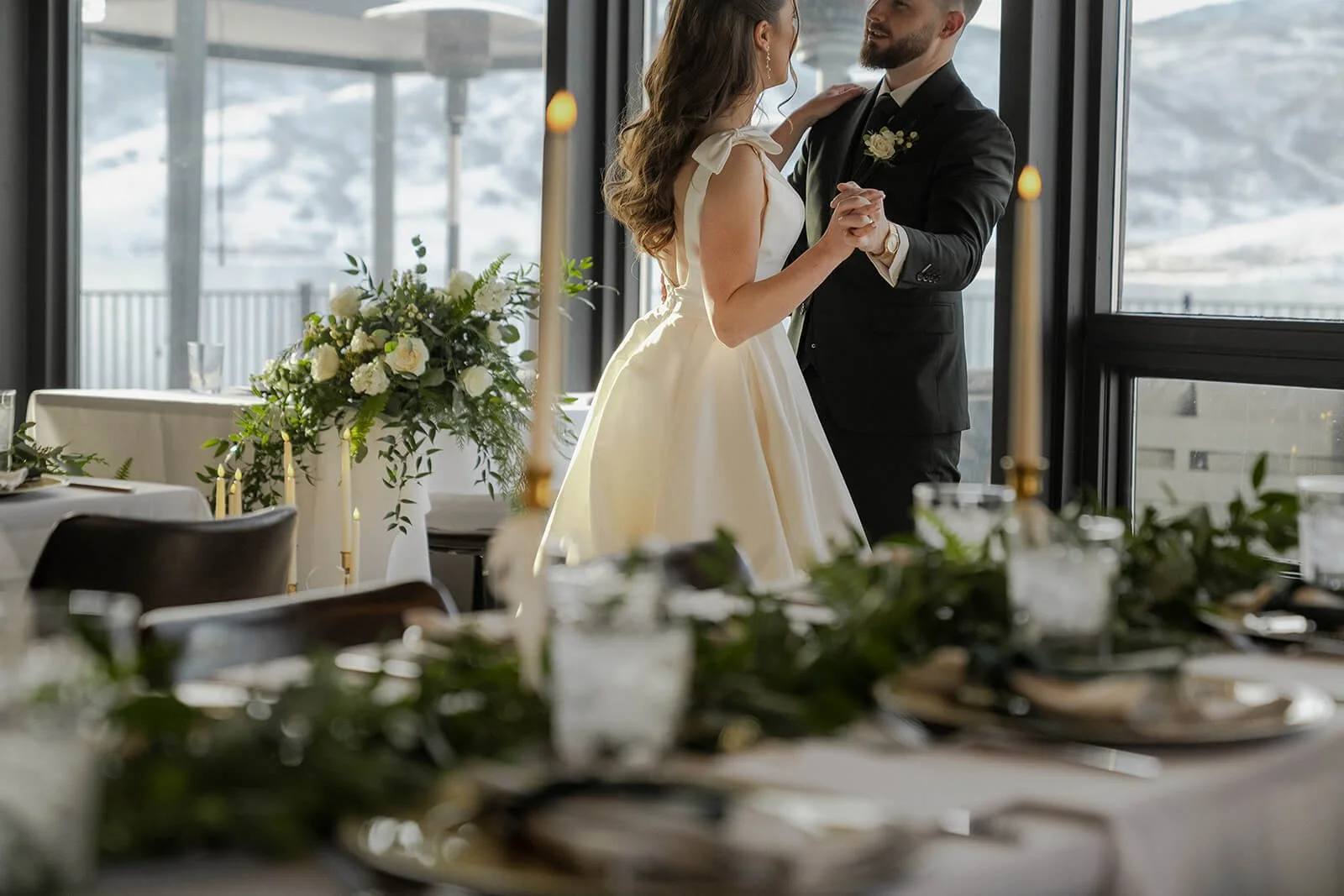 Utah bride and groom dancing with wedding flowers designed by Sprigs of Love.