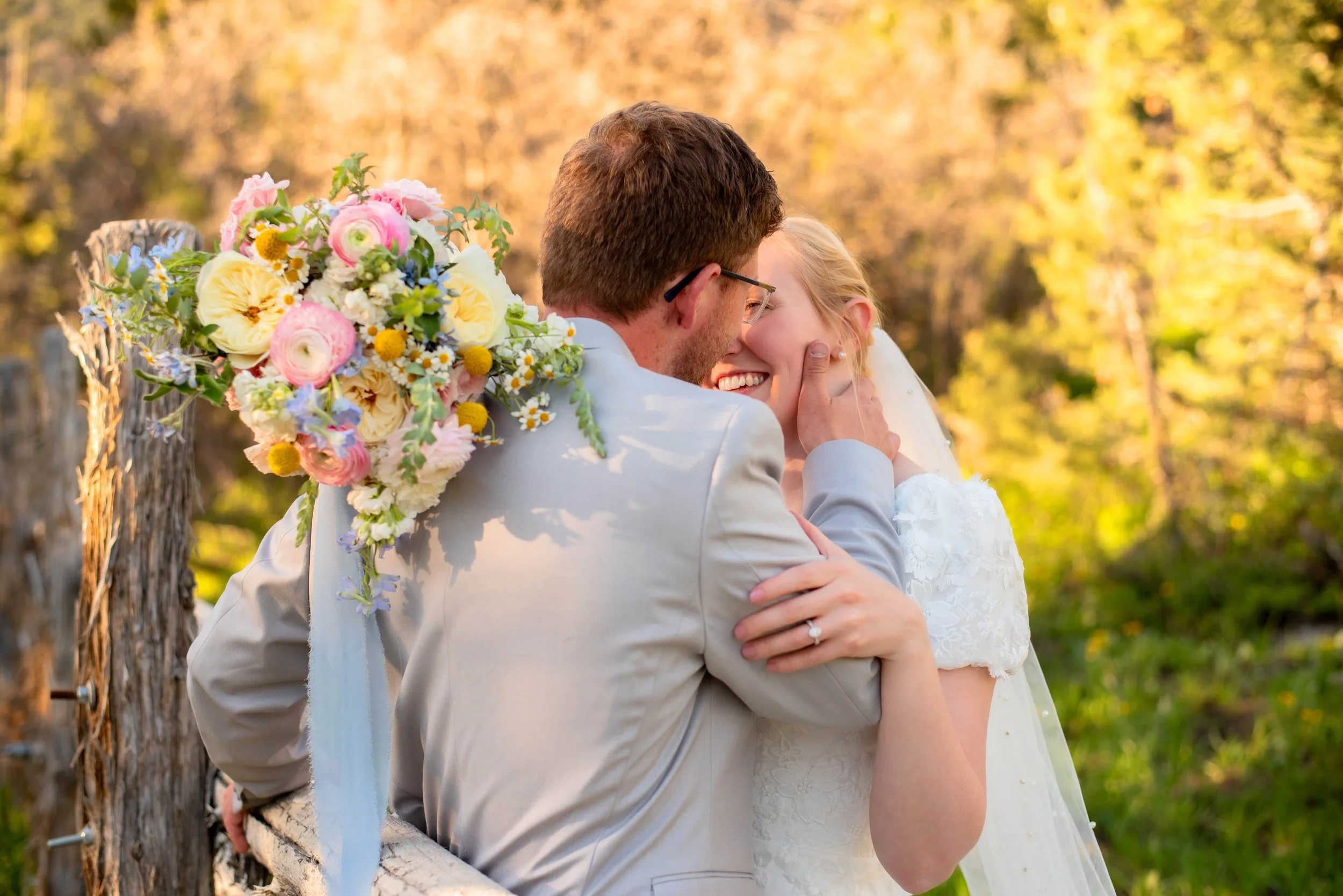 Utah bride and groom holding a Utah bridal bouquet designed by Utah wedding florist, Mikayla Redd of Sprigs of Love.