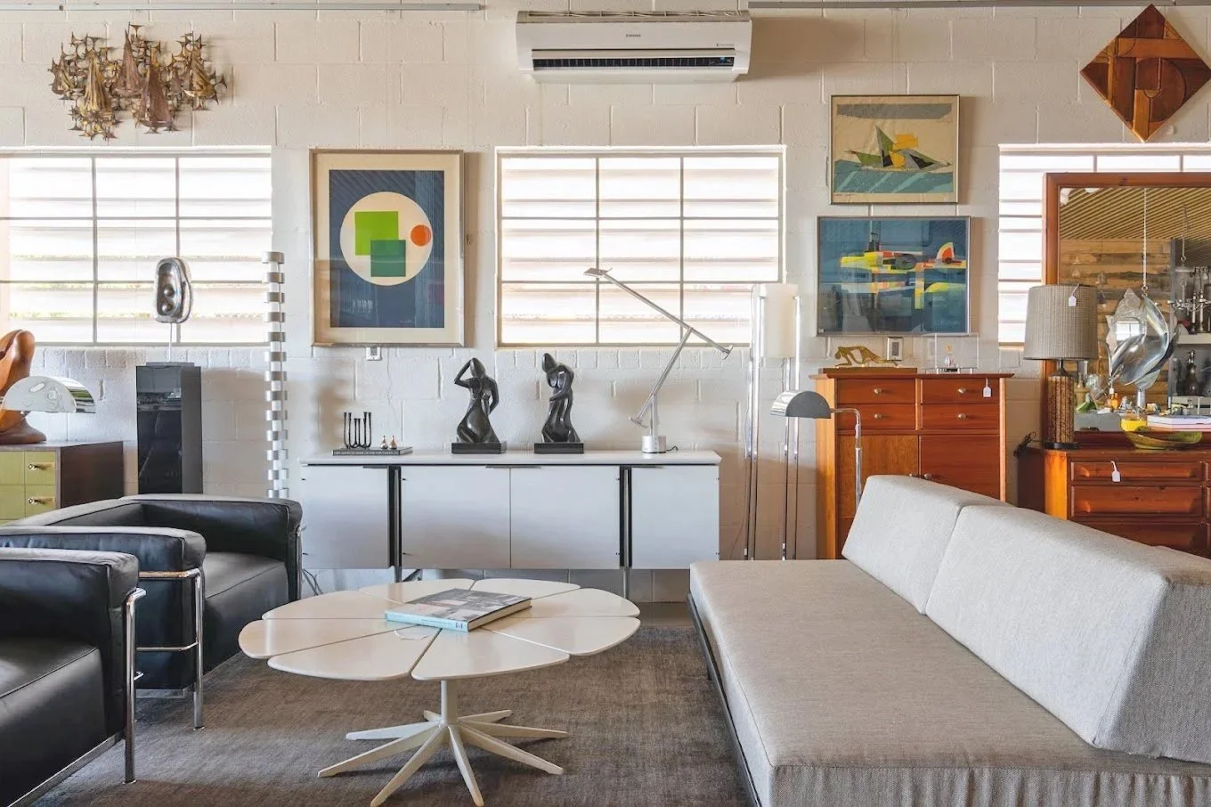 Interior of AZ Modern showcasing  modern and vintage decor, including artwork, sculptures in a contemporary building.