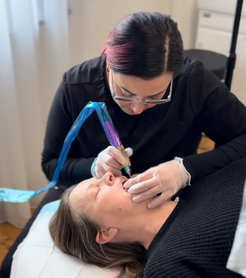 Client receiving a cosmetic tattoo procedure on her lips from a technician in Inst!nkd Beauty & Cosmetic Tattooing, Gawler South Australia