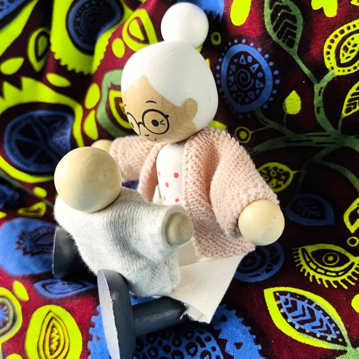Even before babies can talk they have already entered into the world of language. Play allows them to make sense of the world, without words, to enter the space in a way that is meaningful for them. 

IMAGE DESCRIPTION: The image features wooden doll