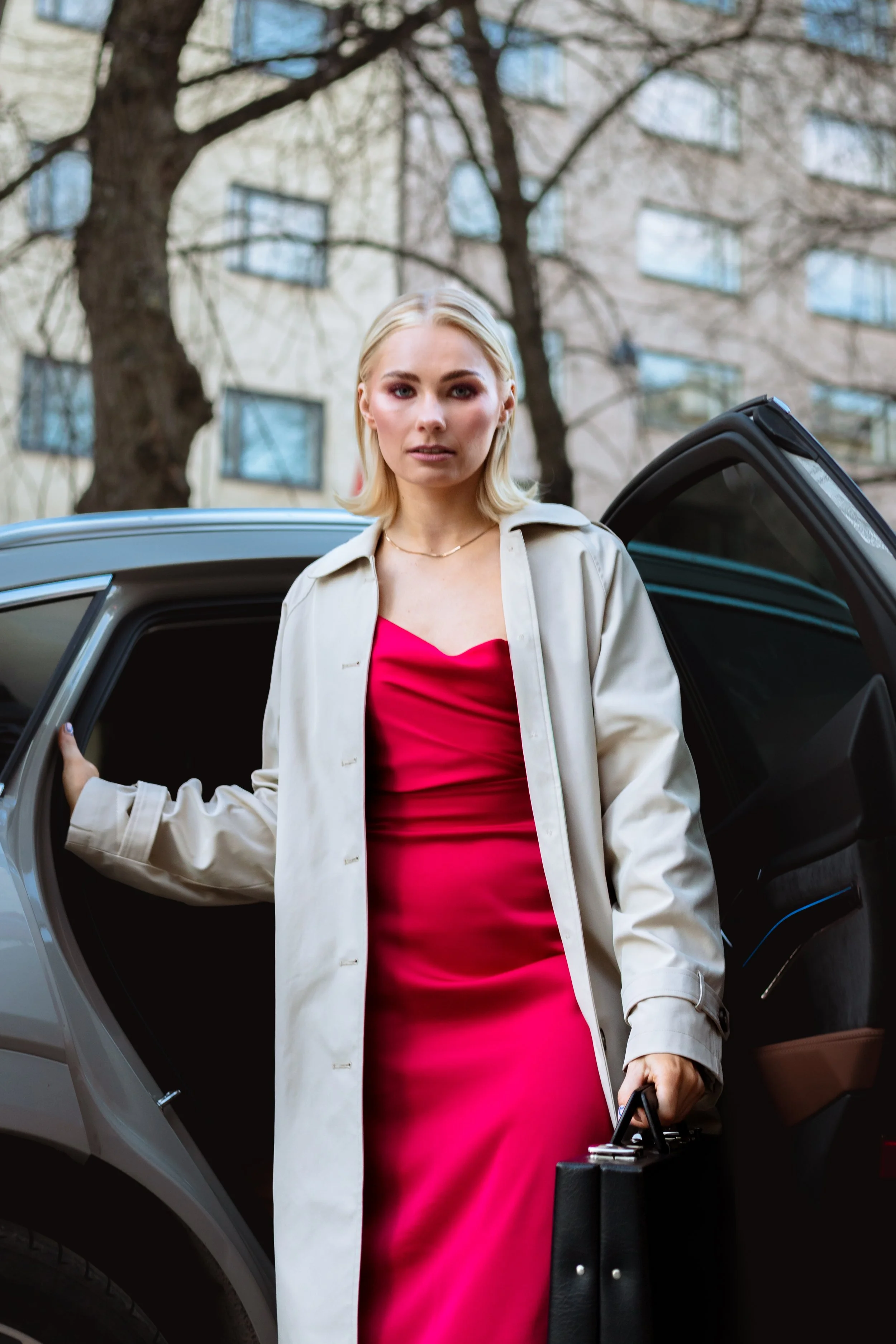 woman in red dress coming out of a car
