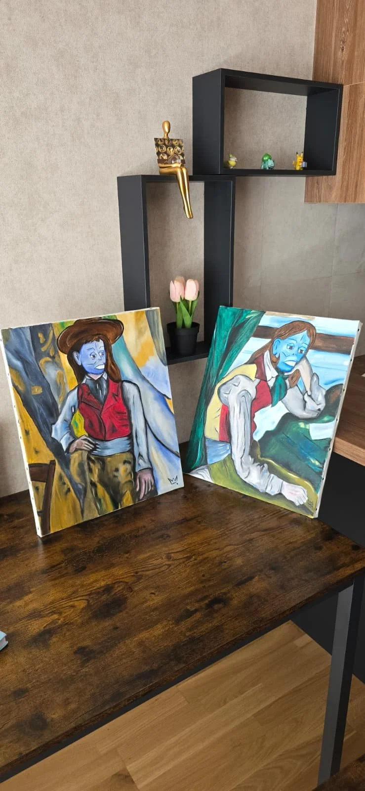 Two paintings of a woman with blue skin, one with a hat and red vest sitting outside, and the other with a red vest and light-colored sleeves sitting indoors.