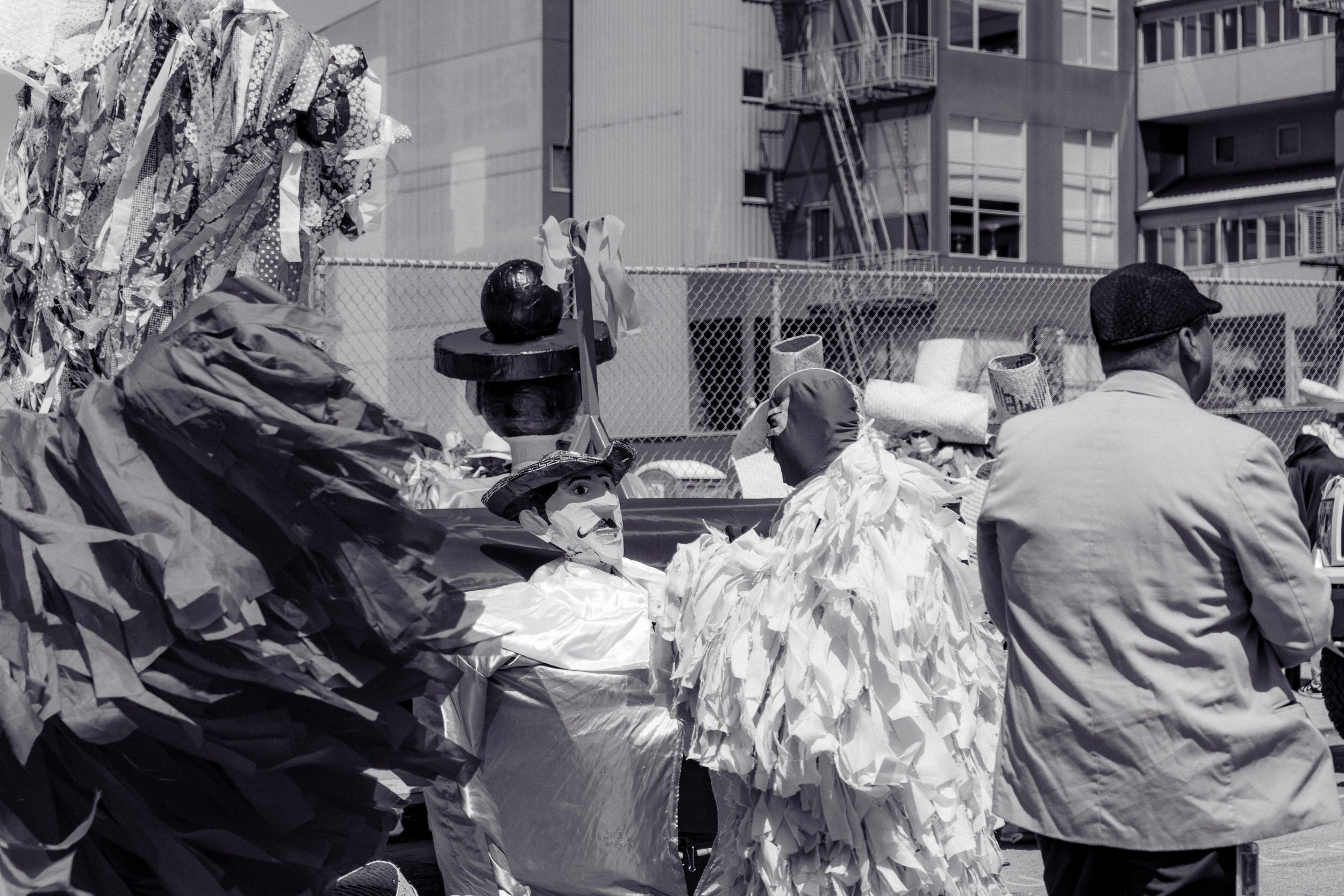Street scene with people and sculptures.