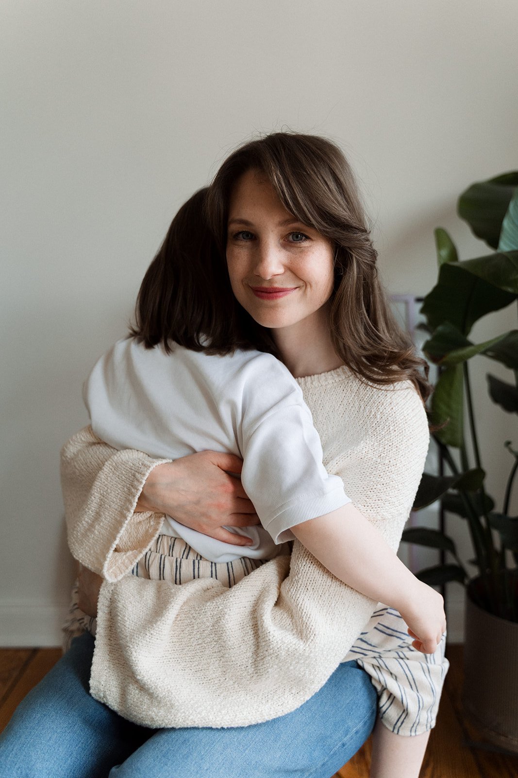 Astrologin und Familiencoach hält Kind auf dem Arm – persönliche Beratung