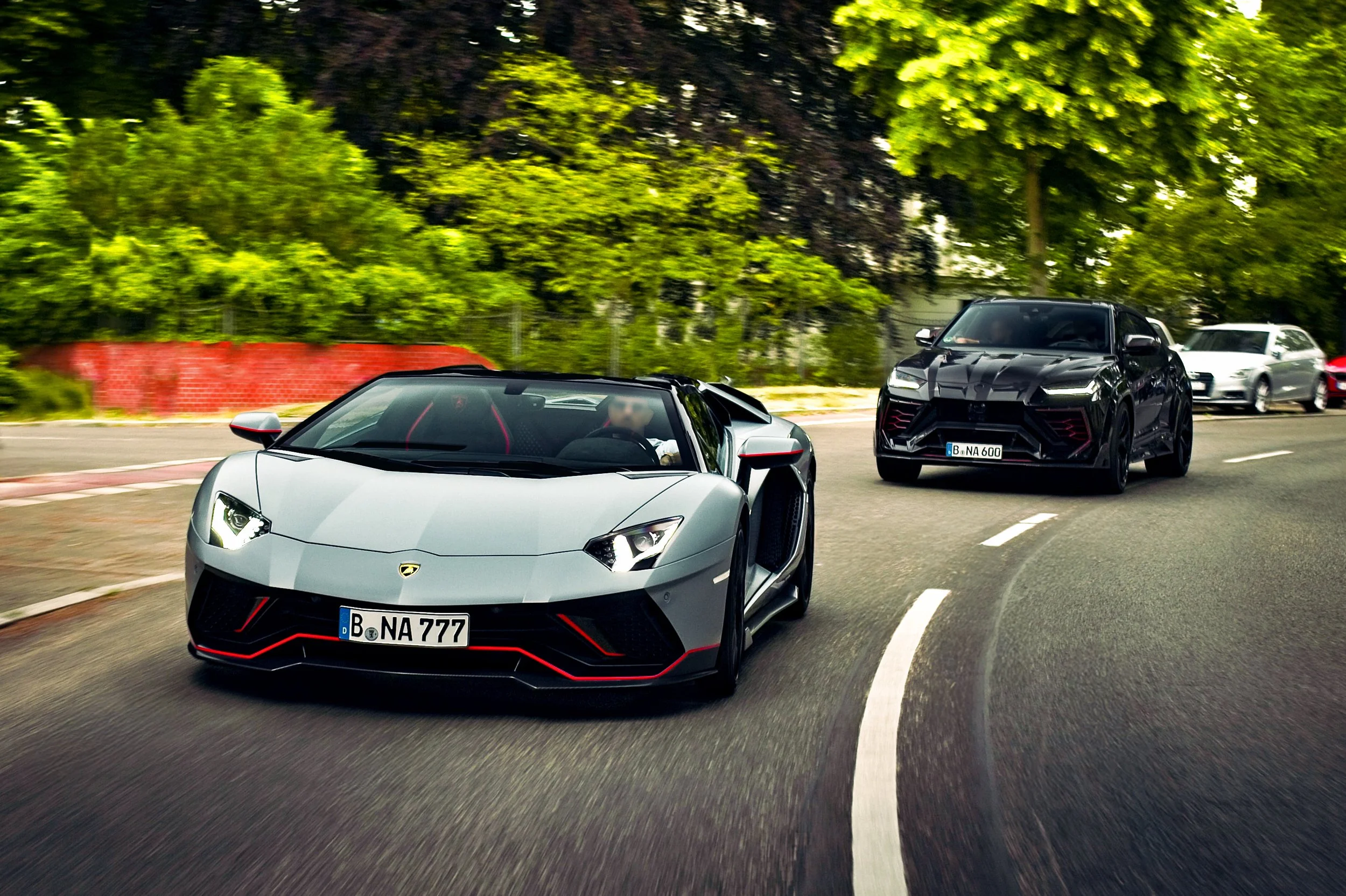Aventador Ultimae Roadster and Mansory Lamborghini Urus driving in Berlin Grunewald Premium Autofotograf Berlin