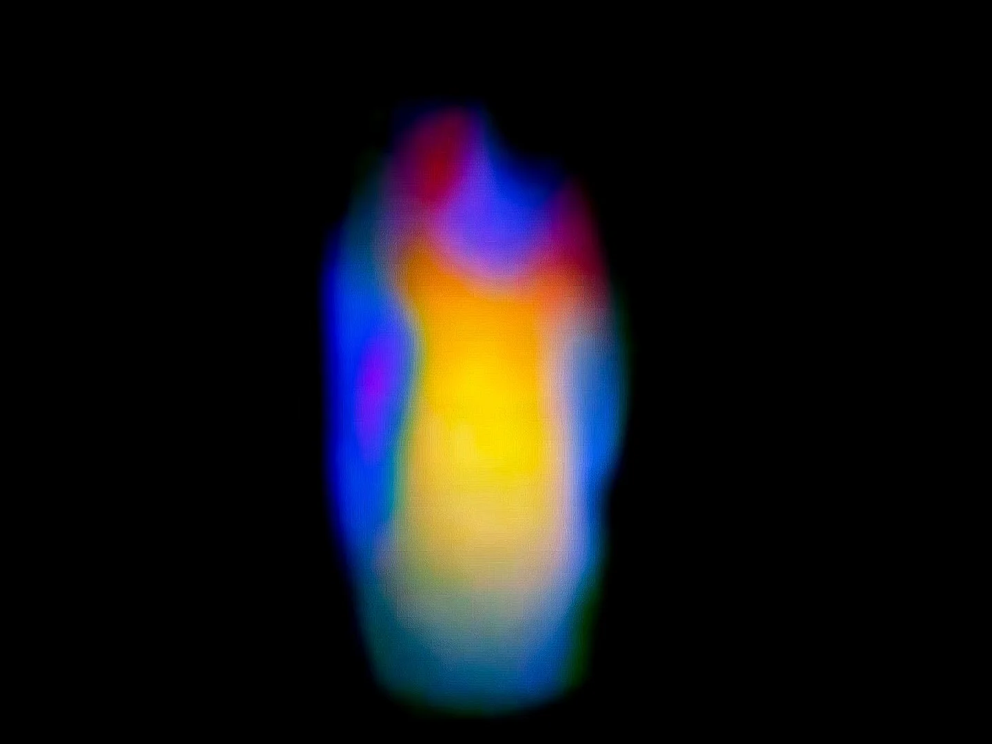 Colorful, abstract, blurred rainbow-colored light streaks against a black background.