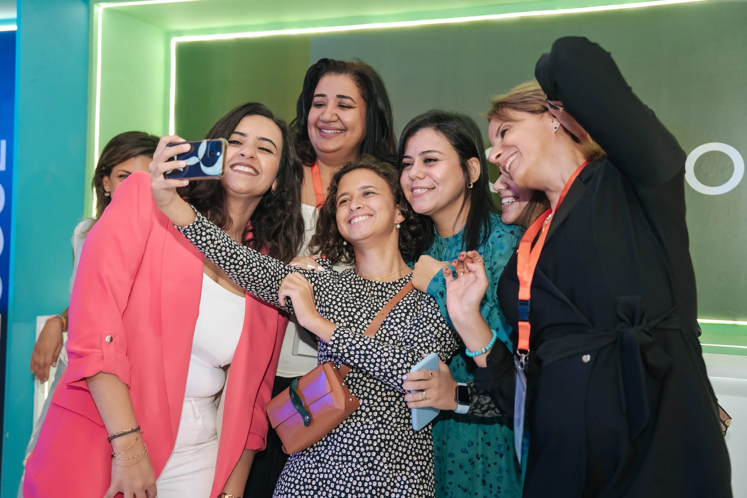 Six women taking a group selfie together, smiling and enjoying themselves at the Regional Sustainable Development Forum, First Edition.