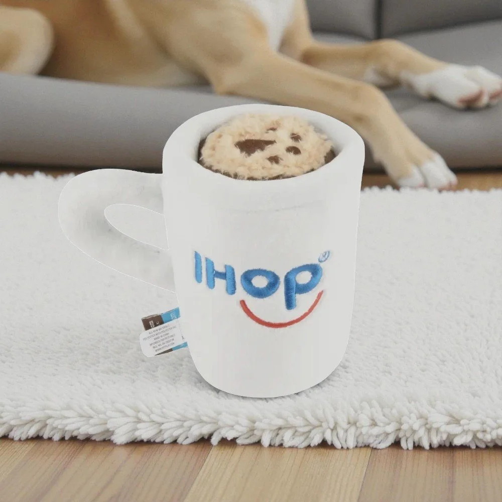 Dog playing with IHOP barking bean brew toy showing durable double layered fabric