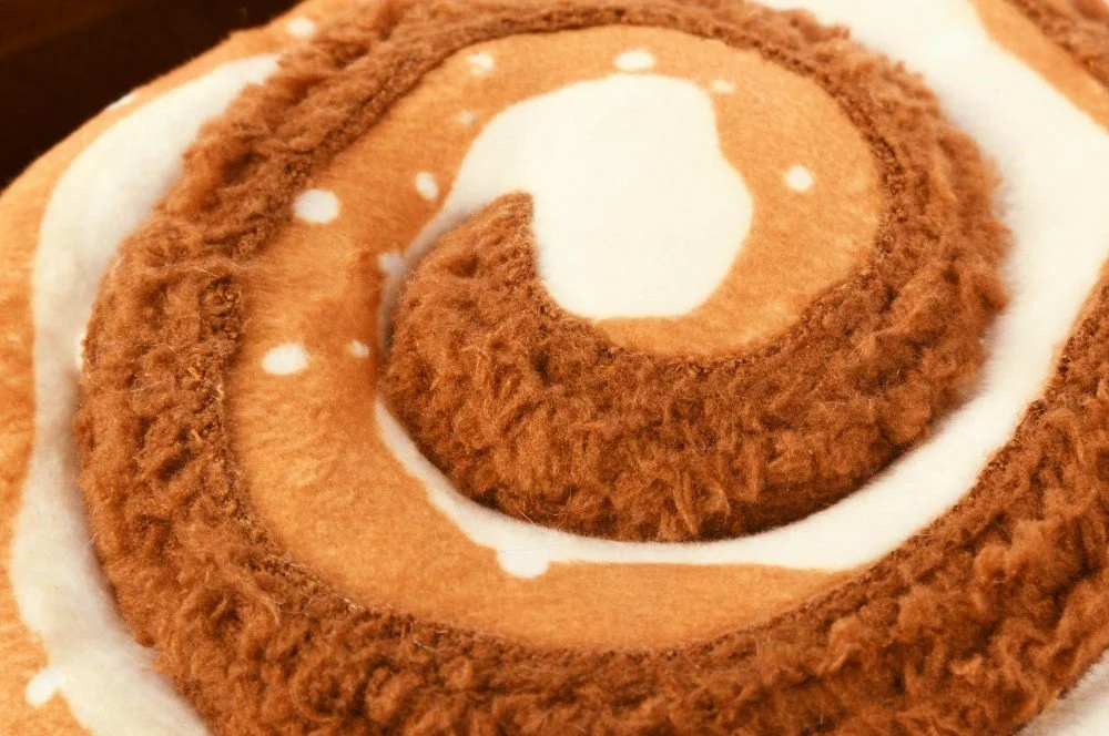 Close up of cinnabone toy showing swirled pattern and double layered fabric construction