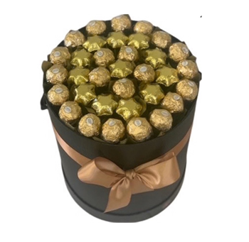 Ferrero Rochers wrapped in gold paper presented in a black hat box