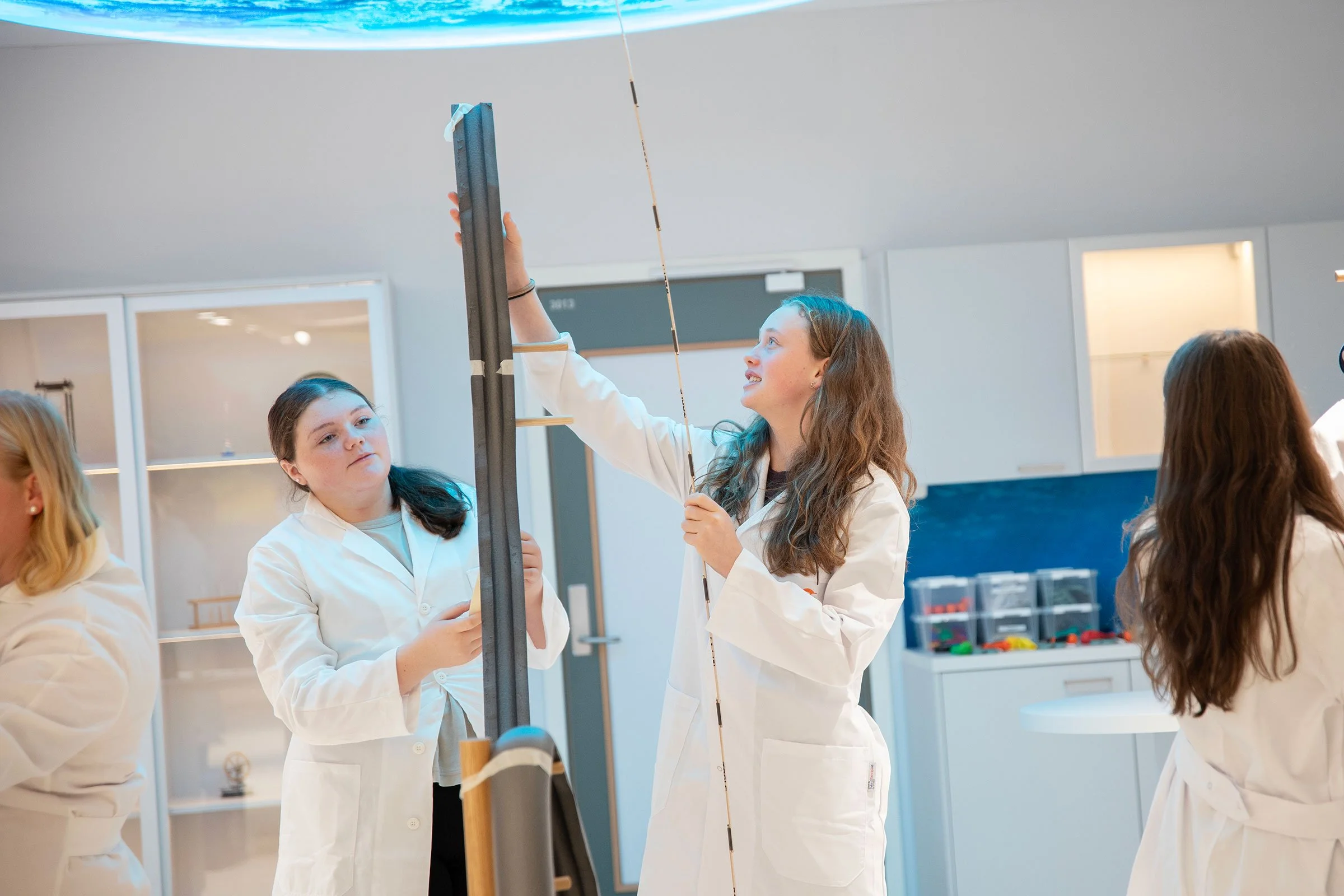 Elever i Newton-rom som holder på med praktiske STEM oppgaver. Her er det fysiske lover og energi som utforskes i modulen, Energisk! - Vi utforsker energi.