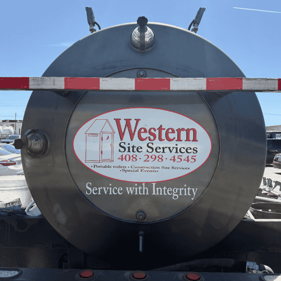 Rear view of a large stainless steel tank with the logo of Western Site Services, including contact phone number and services offered.