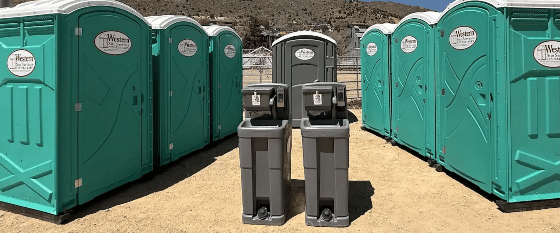 Portable hand wash station rental beside porta potties at a construction site in San Jose