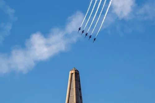 Blue Angels fly in formation over the Transamerica Pyramid, leaving white smoke trails during San Francisco Fleet Week 2023.