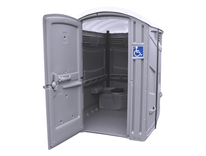 Portable accessible restroom with open door, interior with toilet and seating, located outdoors.
