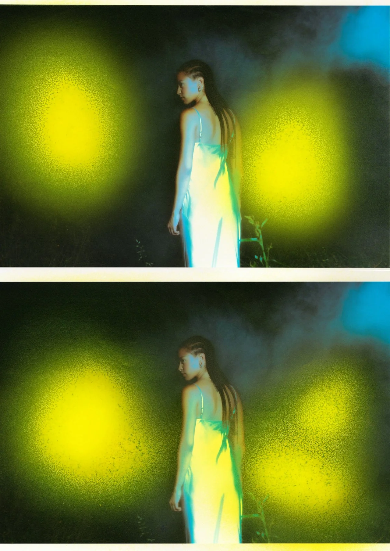A woman wearing a light-colored dress with thin straps, standing outdoors at night, with her body turned to the side and her head facing downward. She is illuminated by yellow-green light spots.