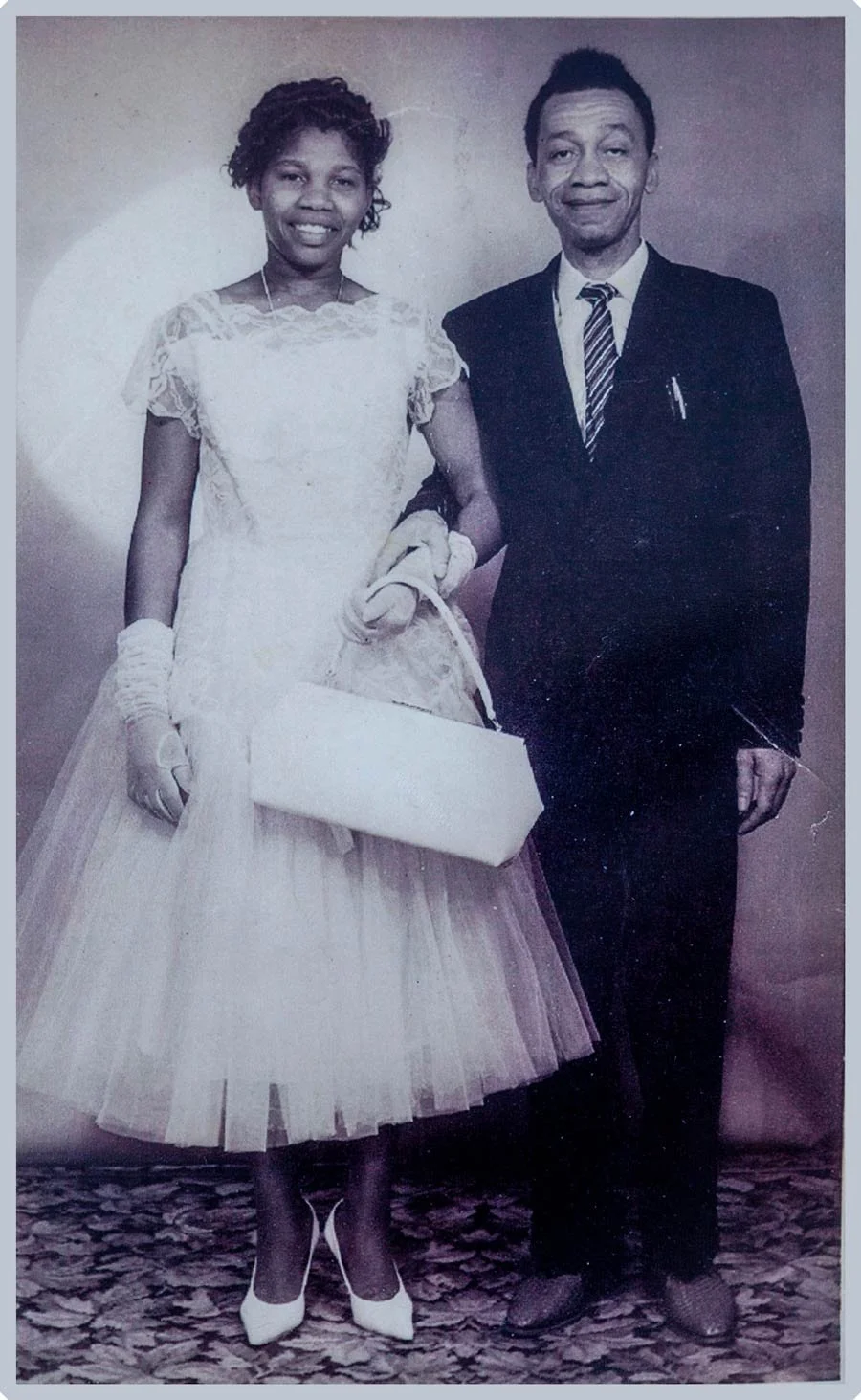 Young Lizzie Jackson pictured in formal 1950s-style attire alongside her partner — a vintage portrait preserved within the Walsall Windrush Sisters archive documenting Caribbean family life and Windrush generation history.