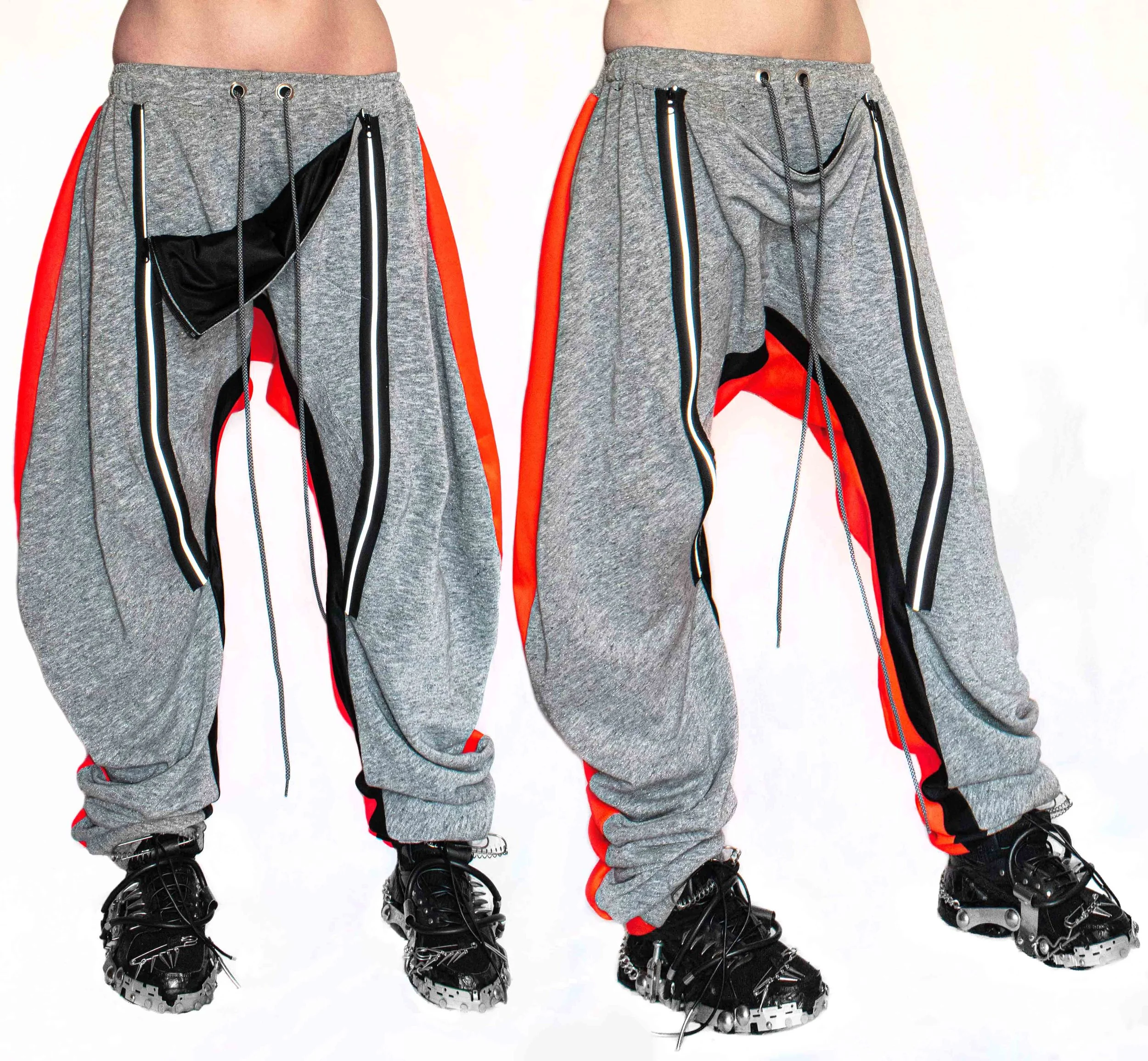 Side view of two people wearing gray sweatpants with red and black accents, black boots, and no shirts, standing against a plain white background.