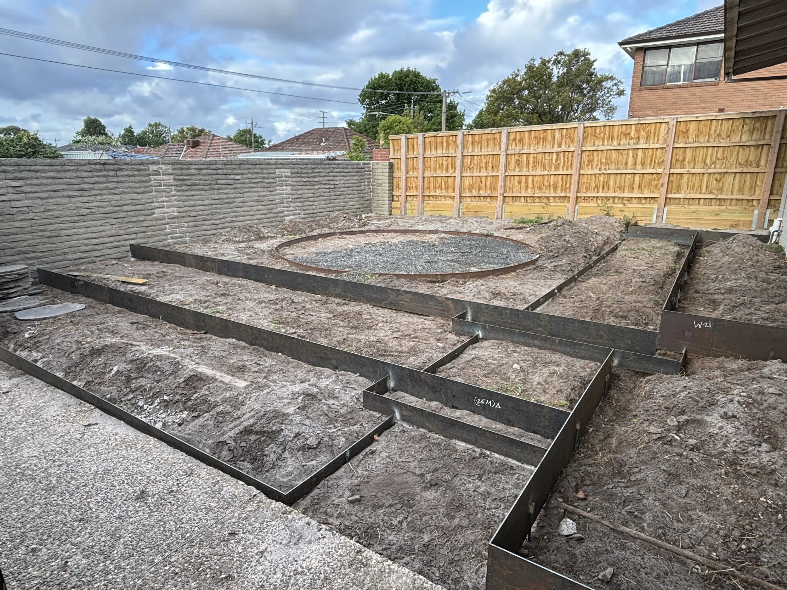 Construction site in backyard with steel and corten framing