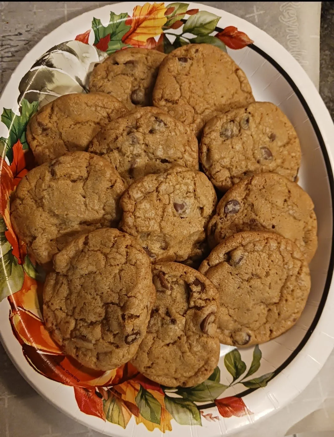 Plate of chocolate chip cookies on a decorative floral plate.