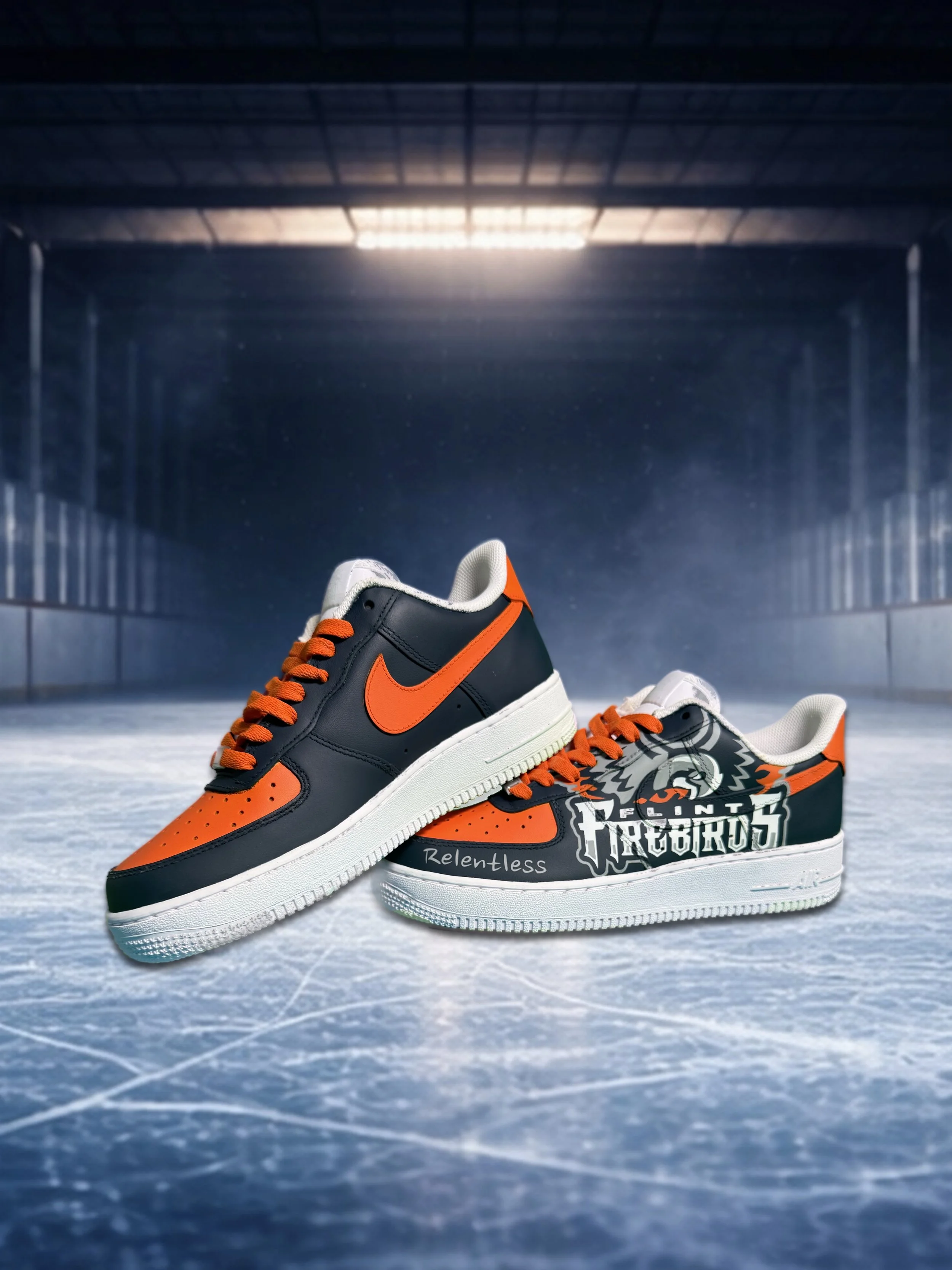 Pair of black and orange Nike sneakers on an ice hockey rink.