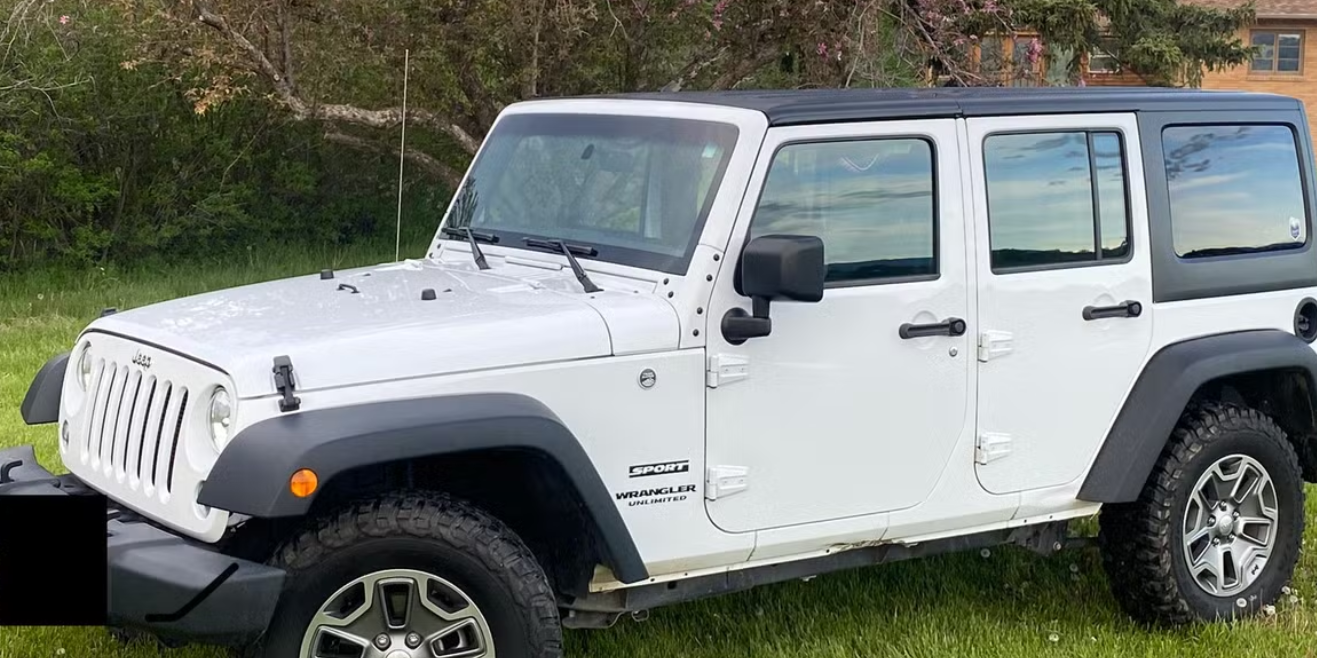White Jeep parked on a lawn