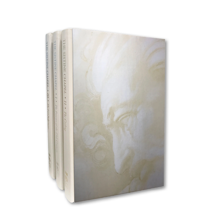 Four books standing upright with a white cover featuring a faint, classical-style profile of a face on the front.