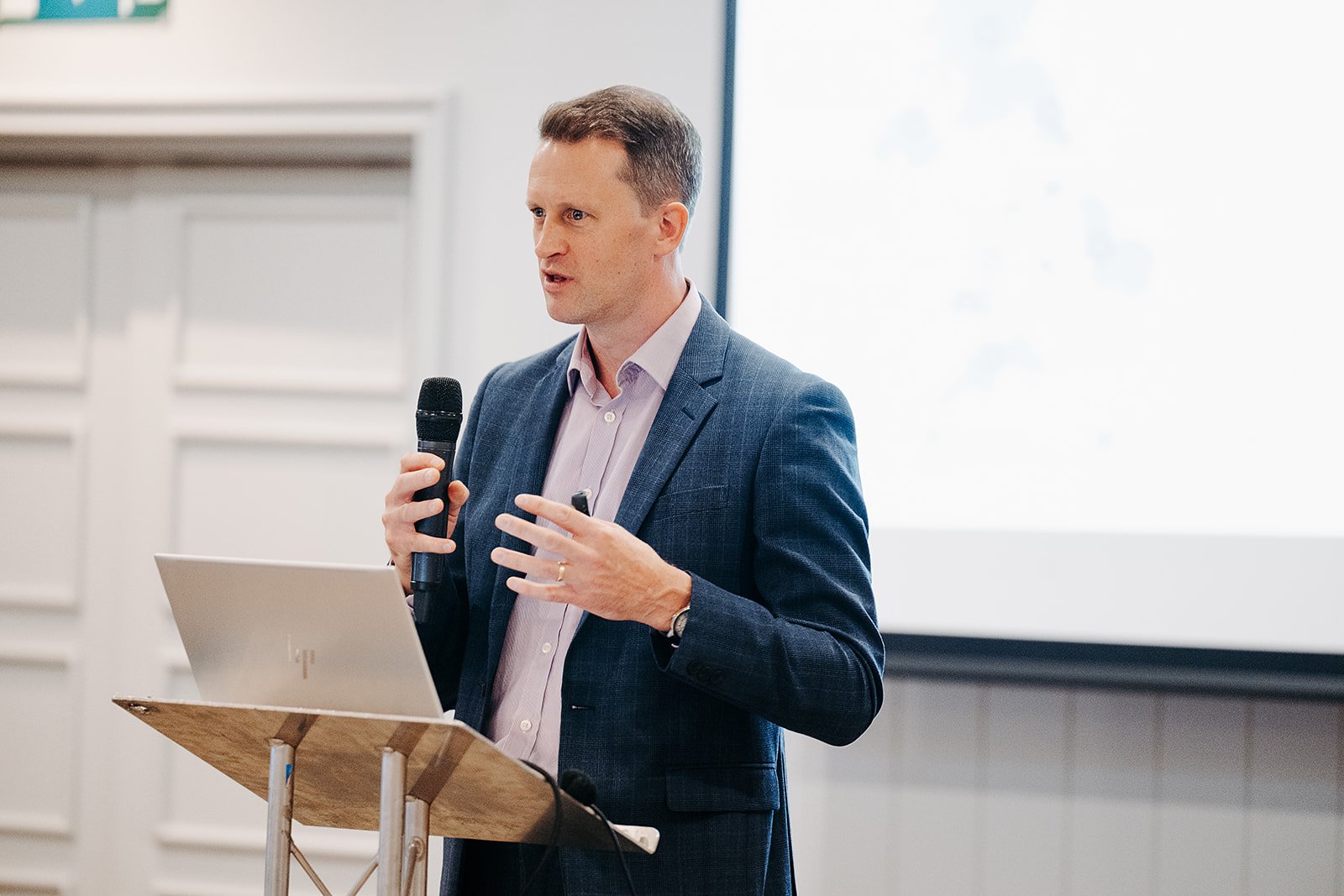 Rick Holland, Deputy Director of Innovate UK, delivering a speech at a podium at the CMO Showcase event for the Scottish BioBased Manufacturing Launchpad programme in Glasgow on 7 October