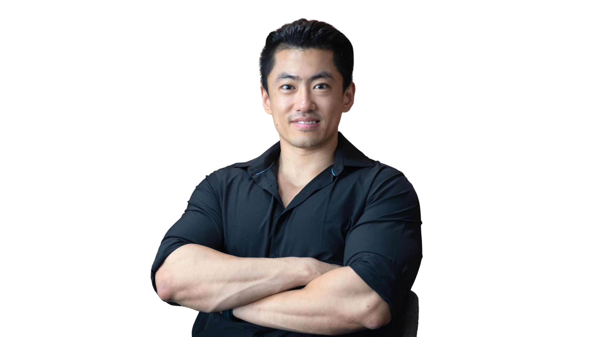 A man with dark hair smiling, wearing a black shirt, in front of a dark background.